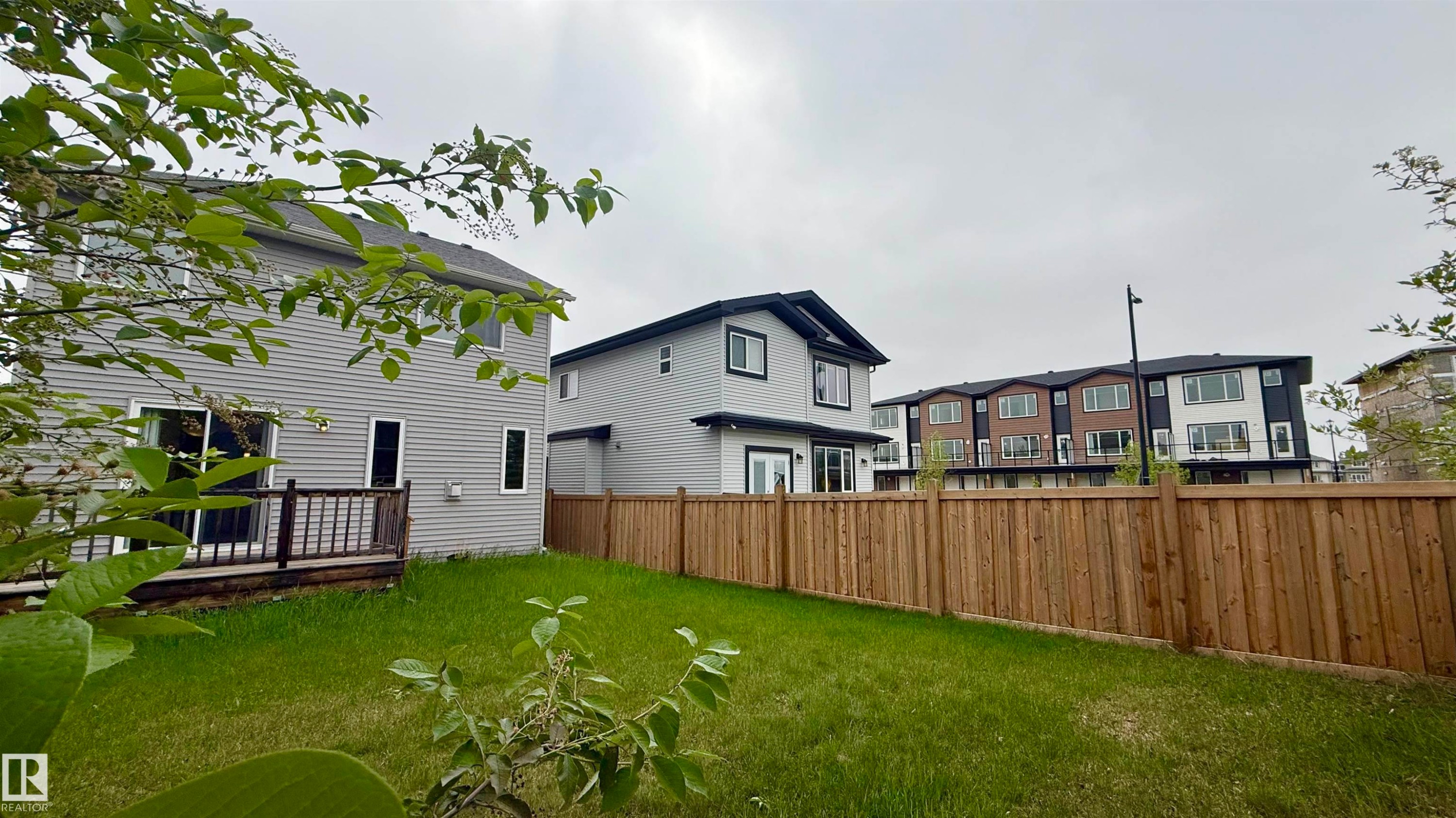 Expansive backyard with wood fencing and a wooden deck - 3962 Claxton Loop, Edmonton, AB - Outdoor With Deck Patio Veranda