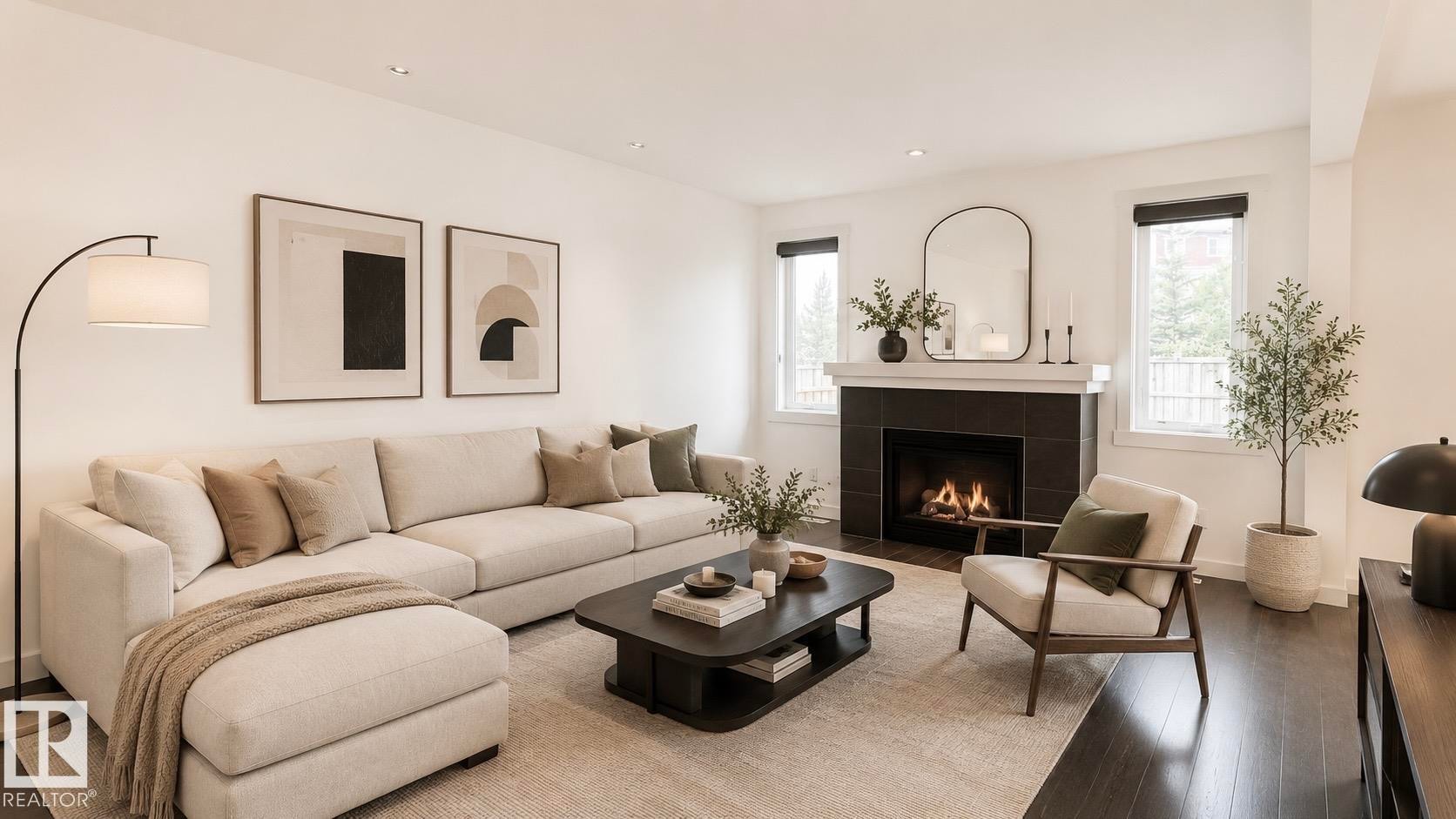 Spacious living area featuring dark wood-finish flooring, a contemporary fireplace with dark tile surround and a white mantel, and multiple windows providing natural illumination - 3962 Claxton Loop, Edmonton, AB - Indoor Photo Showing Living Room With Fireplace