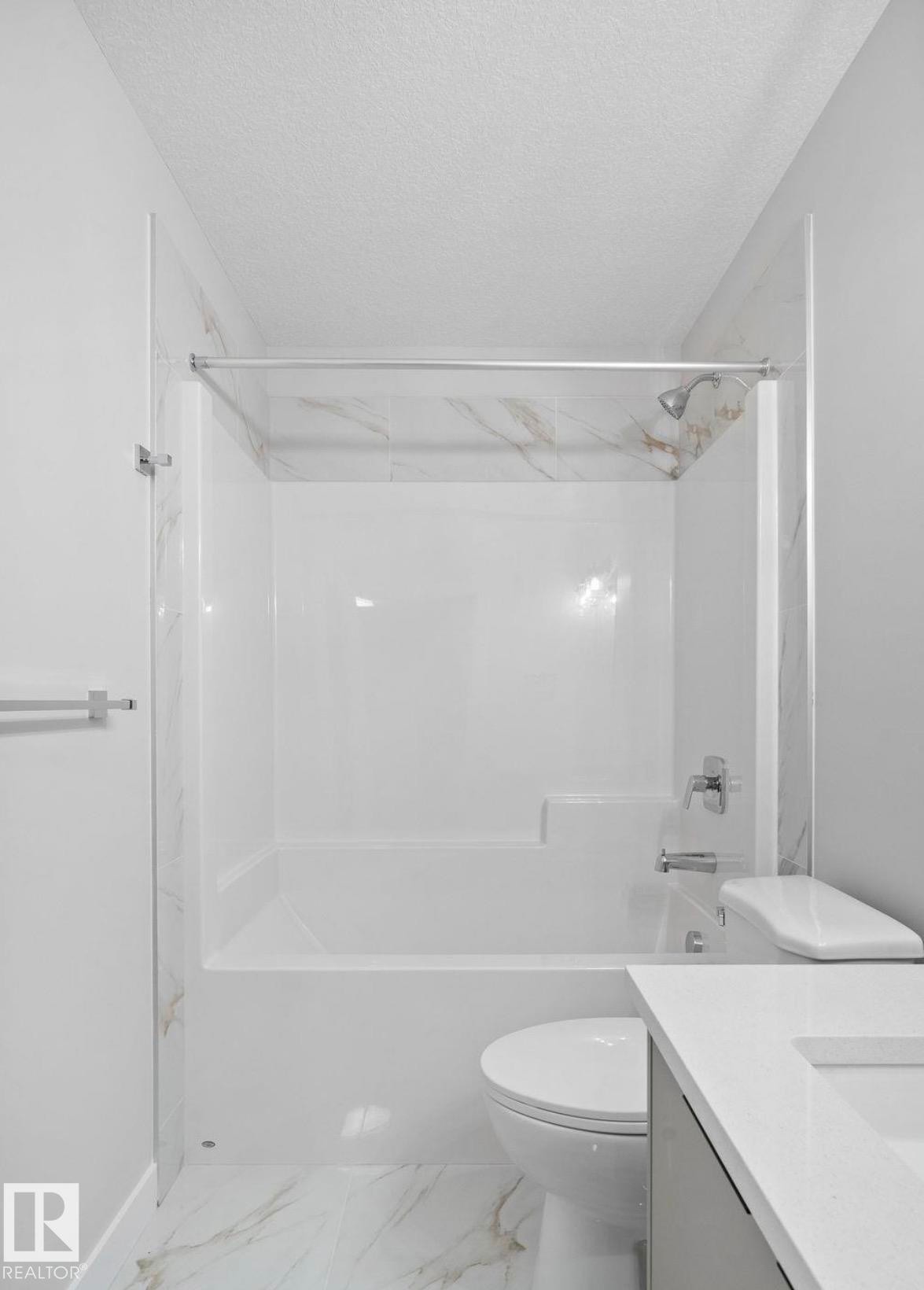 Bathroom featuring a white bathtub/shower combination with a chrome shower head and fixtures - 1511 211 Street Nw, Edmonton, AB