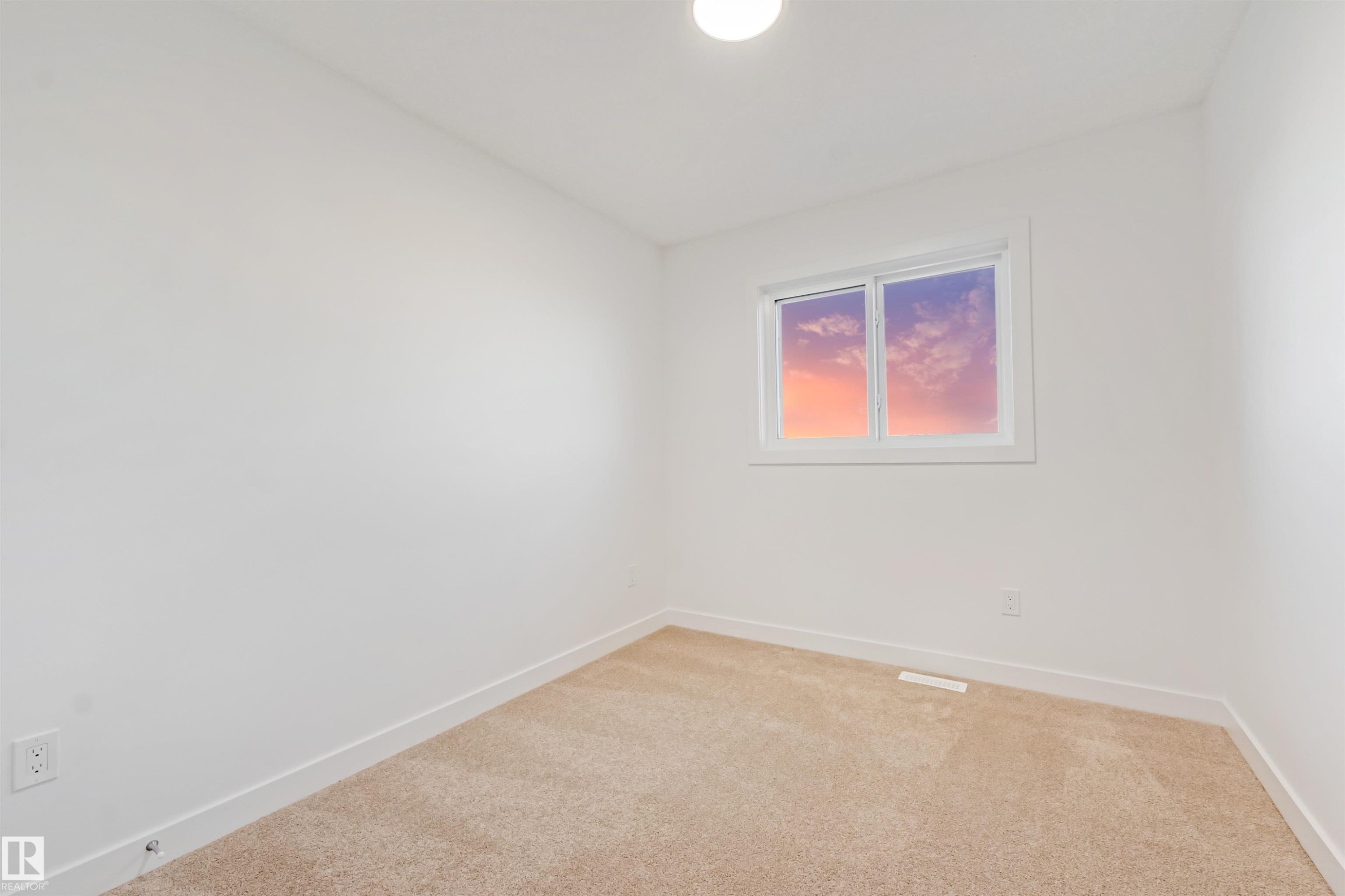 Neutral wall paint with window, overhead light fixture, and plush carpet - 1511 211 Street Nw, Edmonton, AB