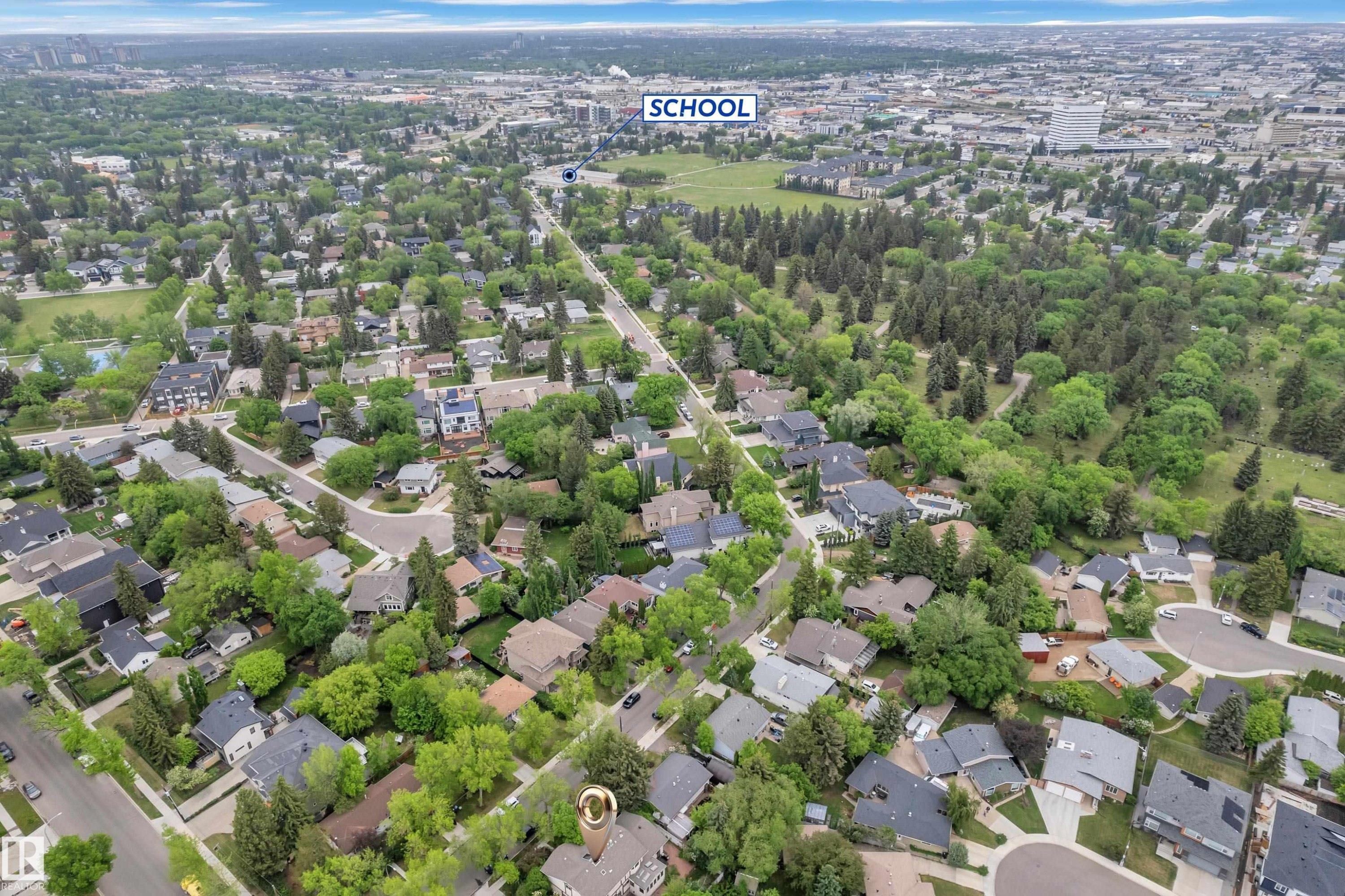 Aerial perspective showcasing a residential neighborhood with abundant mature trees and proximity to extensive green spaces - 10819 54 Avenue, Edmonton, AB