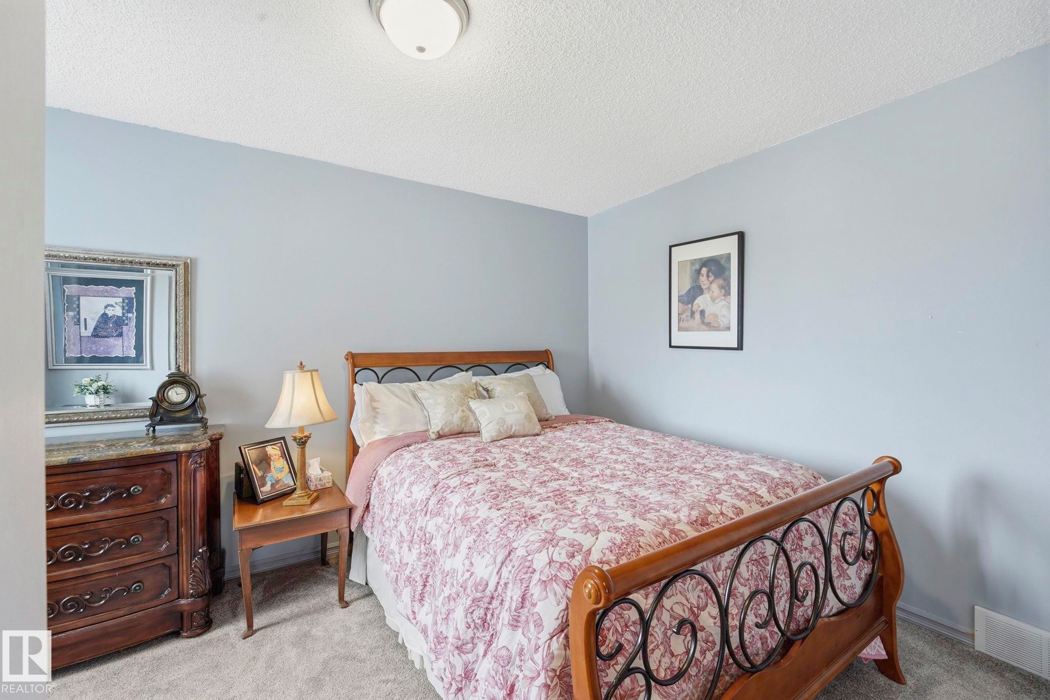 Carpeted room with light blue walls and a white textured ceiling - 3231 28A Avenue Nw, Edmonton, AB - Indoor Photo Showing Bedroom