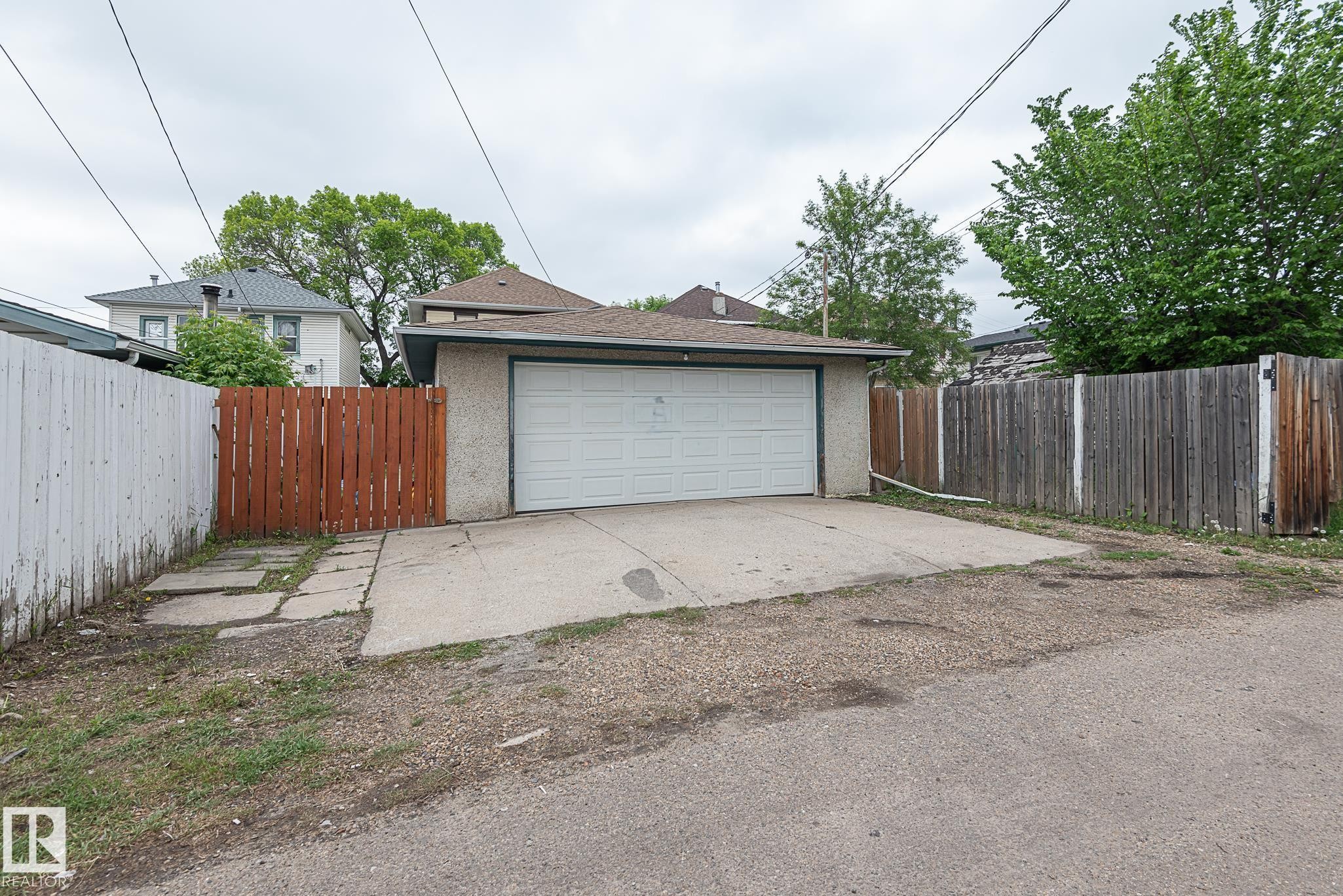 Detached garage with a white overhead door and concrete approach - 9623 110A Avenue, Edmonton, AB
