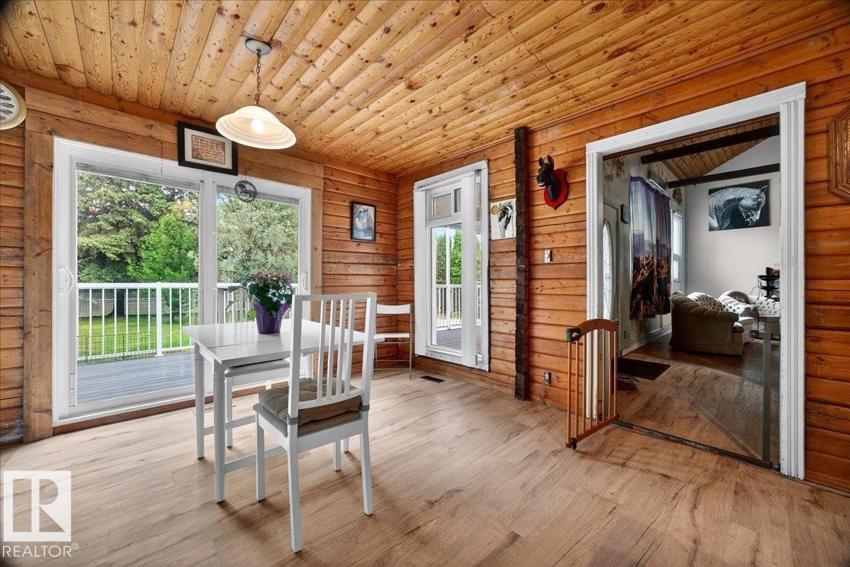 Wood-finish flooring throughout, complemented by a wood-plank ceiling and walls - 140 50047 Rge Rd 244, Rural Leduc County, AB
