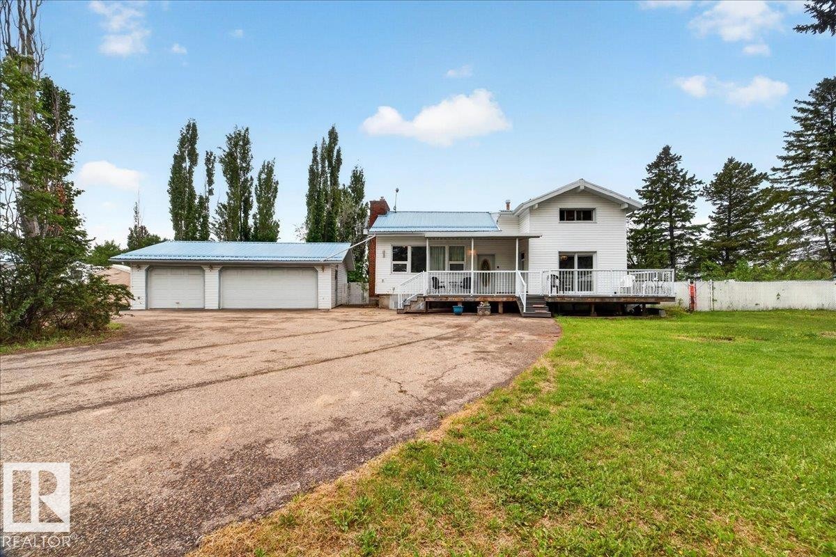 White exterior with light blue metal roofing - 140 50047 Rge Rd 244, Rural Leduc County, AB