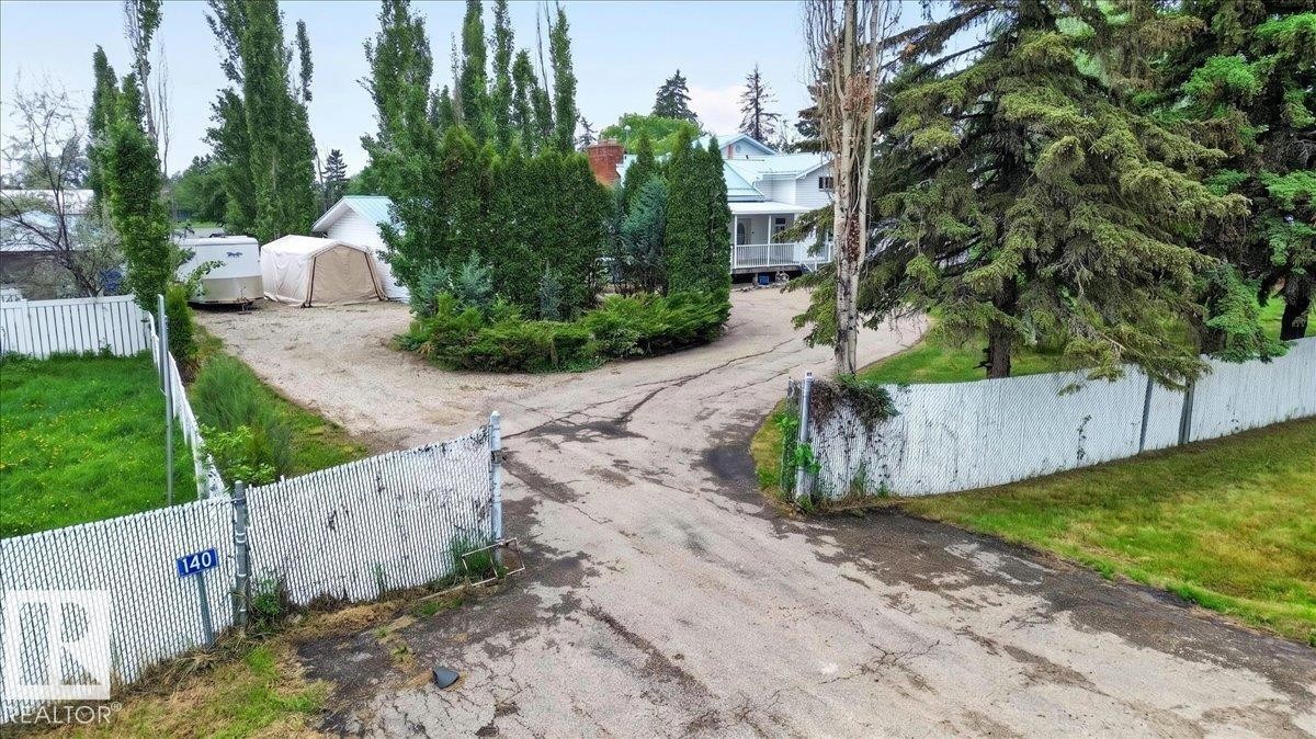 Gated access with chain link fencing and a partial privacy fence - 140 50047 Rge Rd 244, Rural Leduc County, AB
