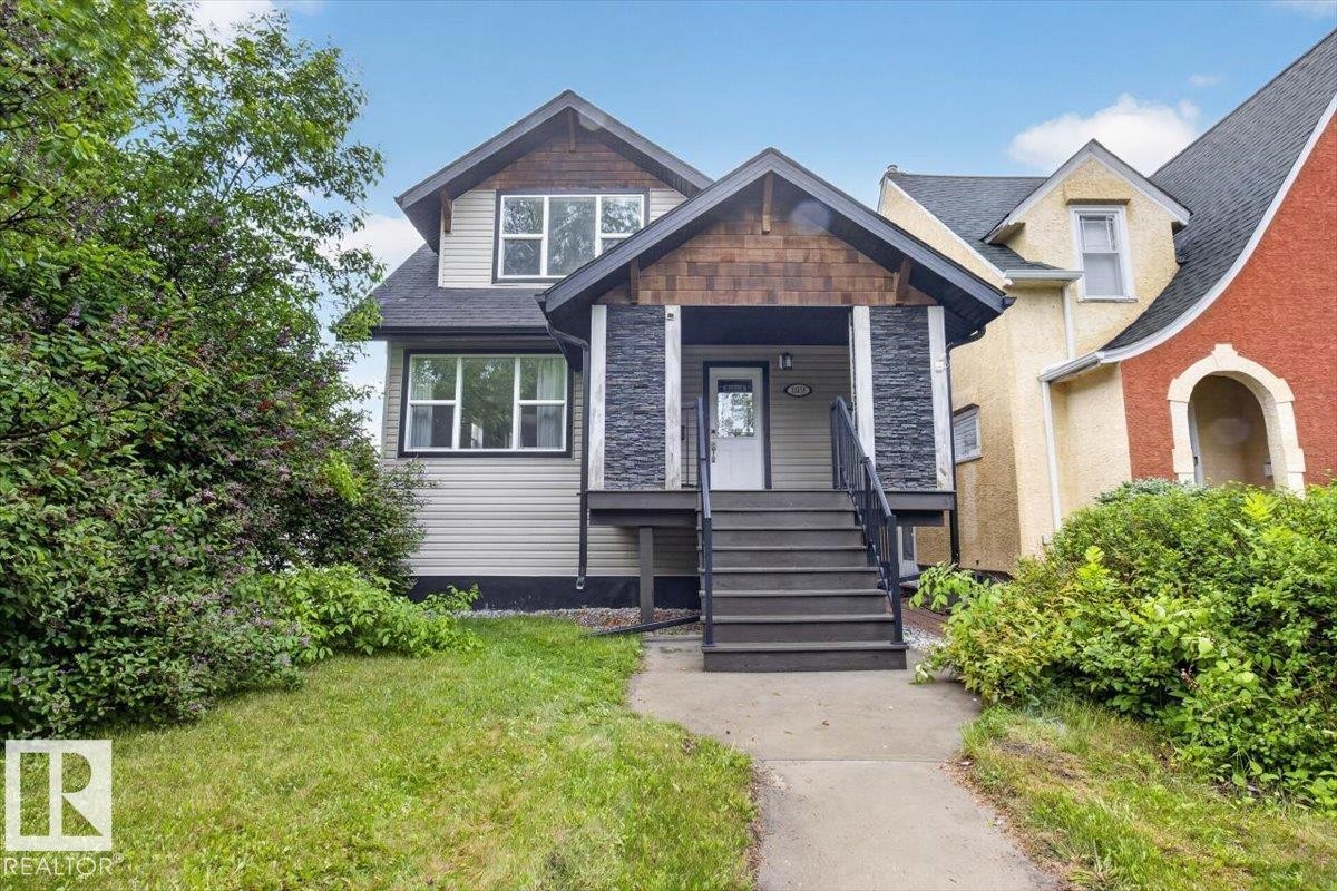 Two-story residence featuring light-colored siding and a dark shingled roof - 10958 88 Avenue, Edmonton, AB