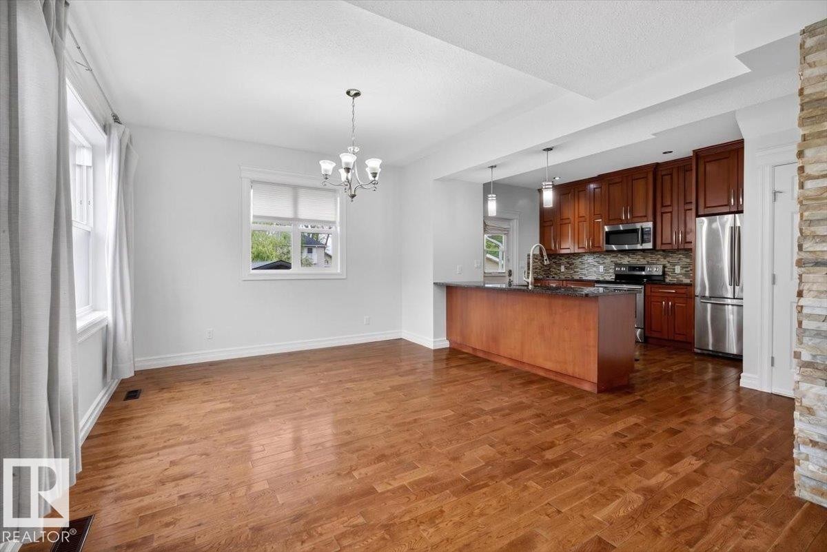 Open concept living space featuring wood-finish flooring throughout - 10958 88 Avenue, Edmonton, AB