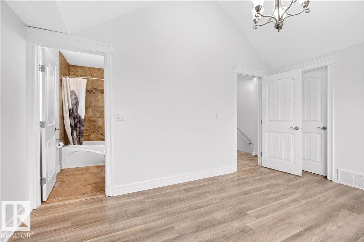 Vaulted ceiling room with wood-finish flooring - 10958 88 Avenue, Edmonton, AB
