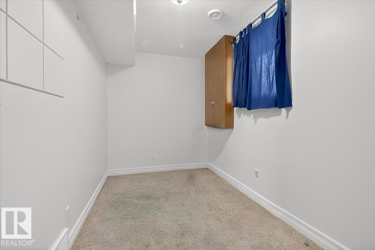 Compact room with neutral wall paint and carpeted flooring - 10958 88 Avenue, Edmonton, AB
