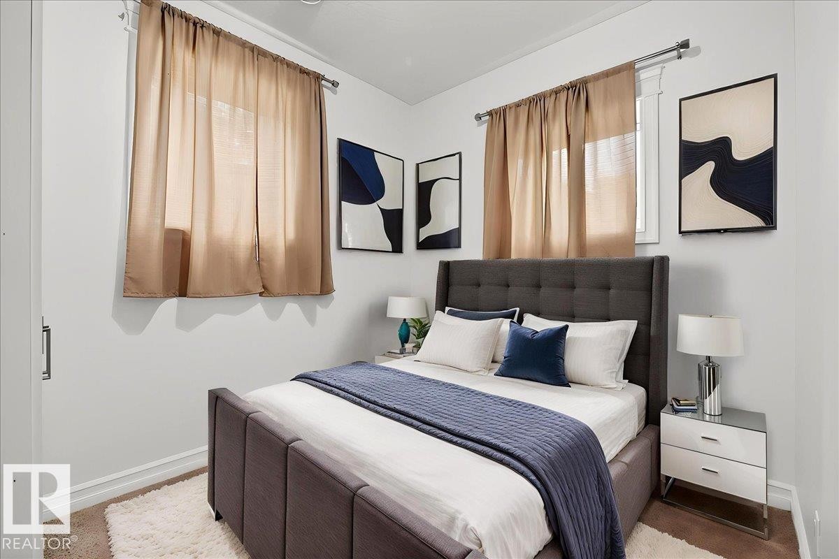Bright bedroom featuring neutral wall tones and carpeted flooring - 10958 88 Avenue, Edmonton, AB
