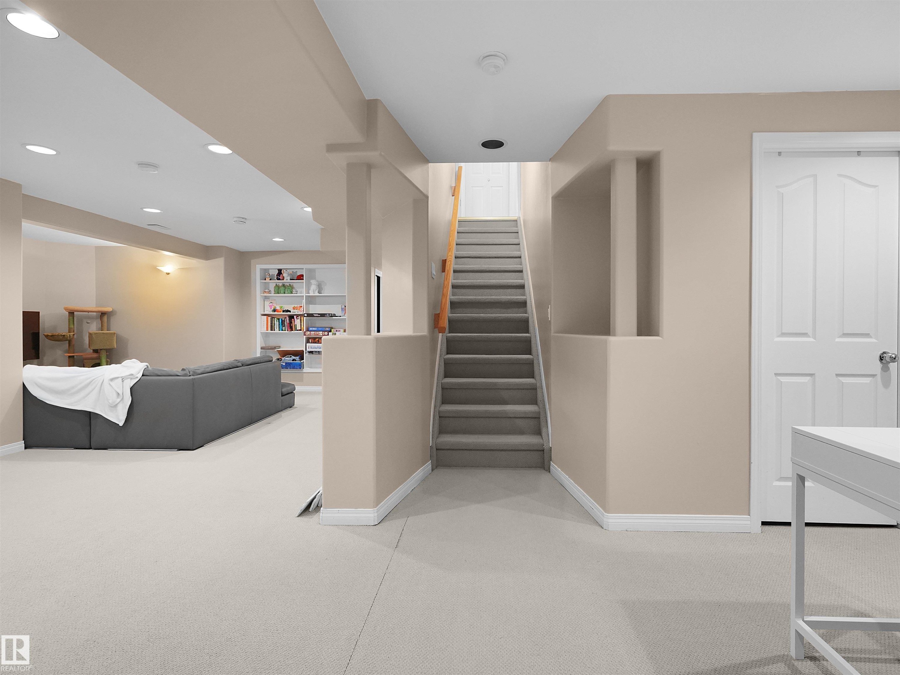 Carpeted staircase with light beige walls and white trim - 208 Ferguson Place, Edmonton, AB