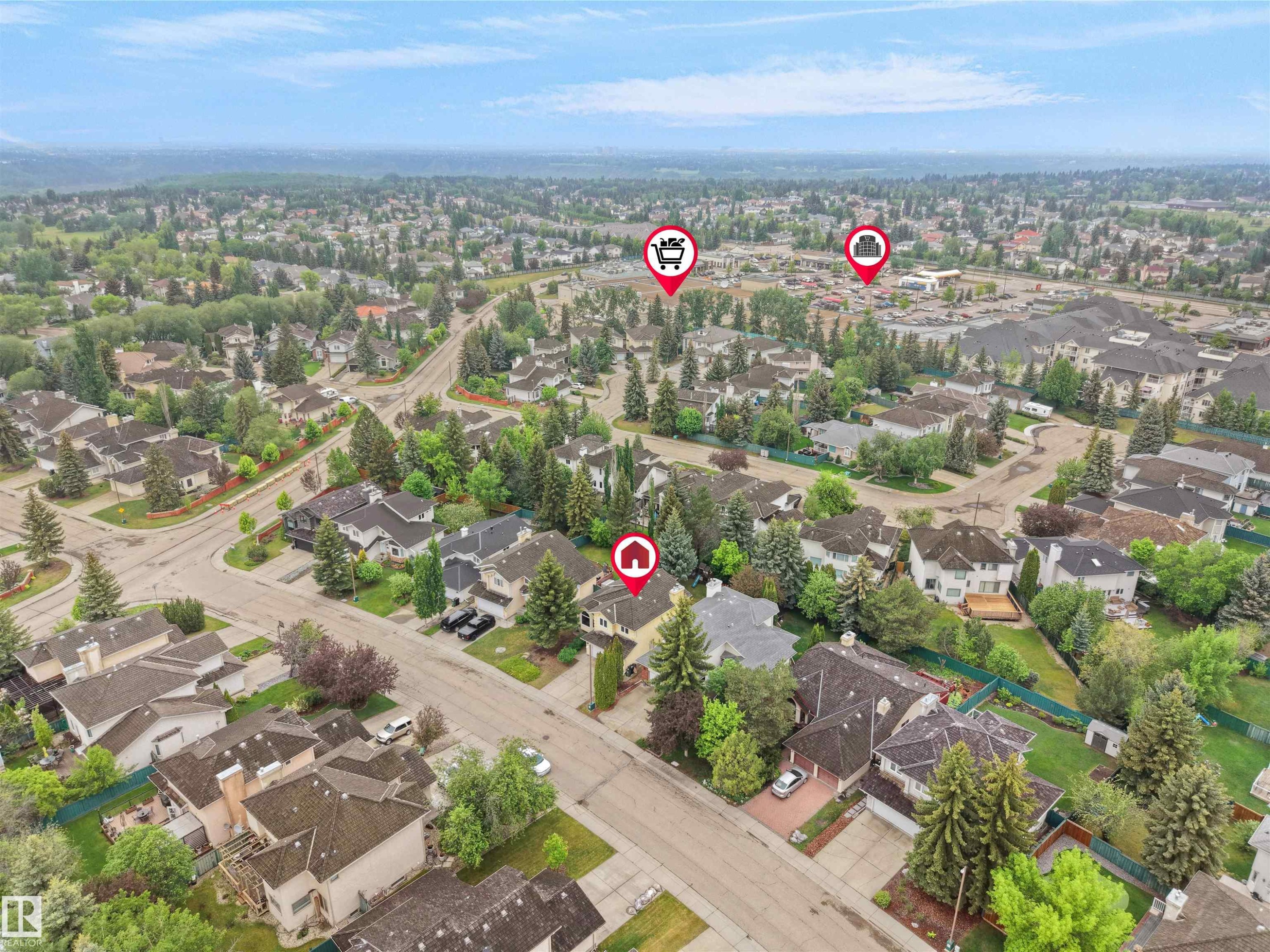 Expansive residential area featuring numerous detached homes with mature landscaping and a mountainous backdrop - 208 Ferguson Place, Edmonton, AB
