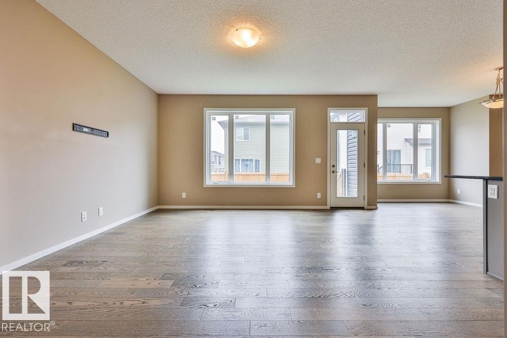 Spacious interior with durable wood-finish flooring throughout - 2031 207 Street, Edmonton, AB