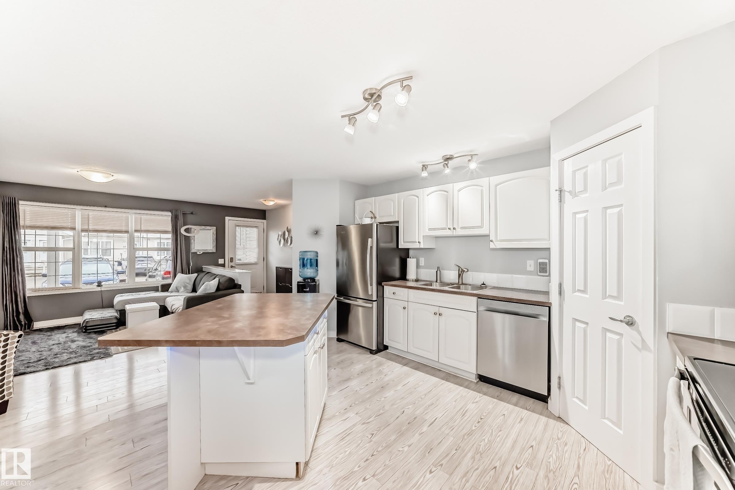 Open-concept living space featuring wood-finish flooring - 53 150 Edwards Drive, Edmonton, AB