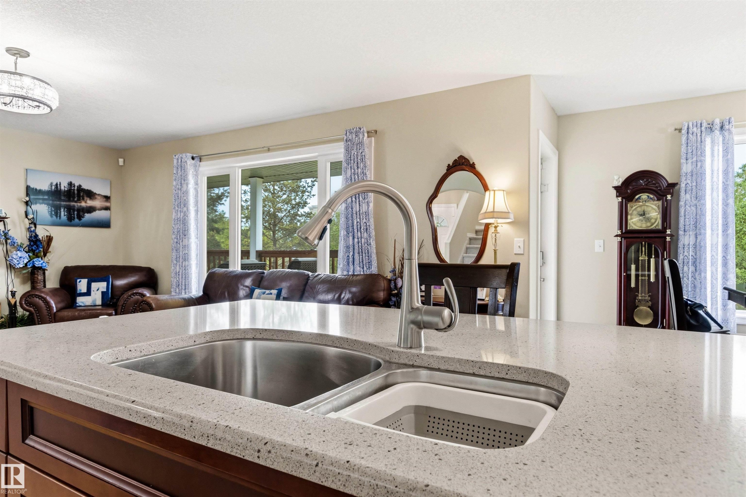 Kitchen island featuring a double basin stainless steel sink with an integrated drying rack - 32 Lamplight Bay, Spruce Grove, AB