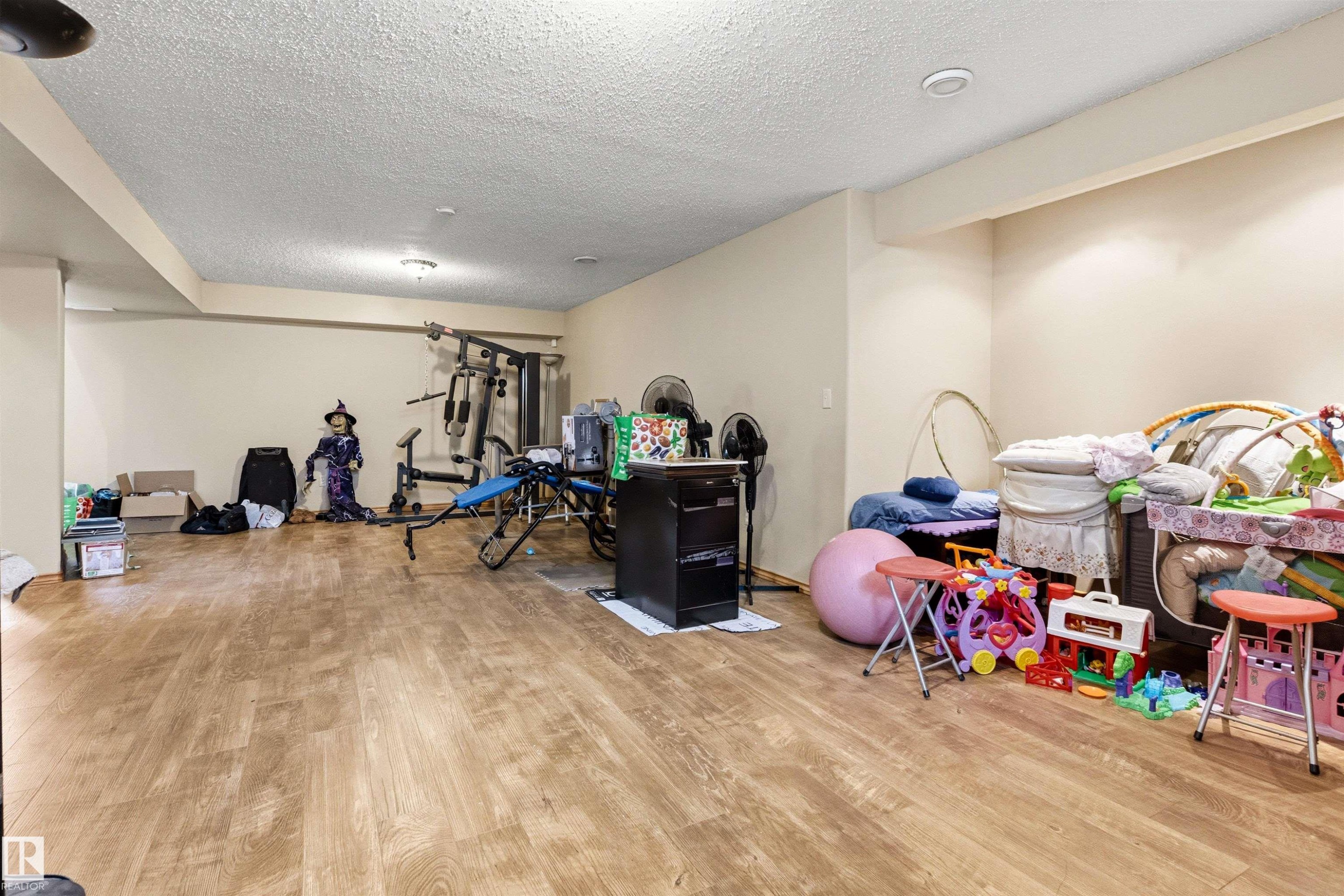 Spacious lower level featuring wood-finish flooring, recessed lighting, and light-toned walls - 32 Lamplight Bay, Spruce Grove, AB