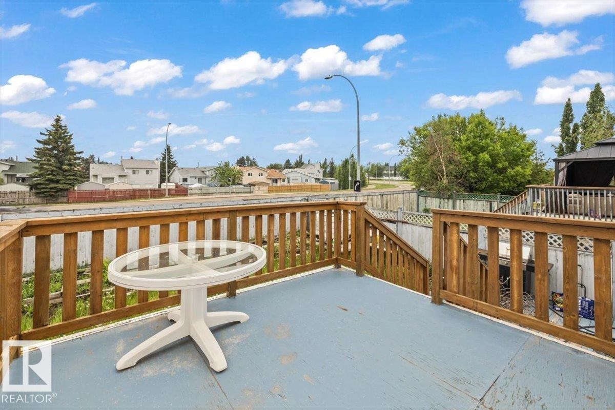 Spacious outdoor deck featuring wooden railings and steps - 8103 154 Avenue, Edmonton, AB
