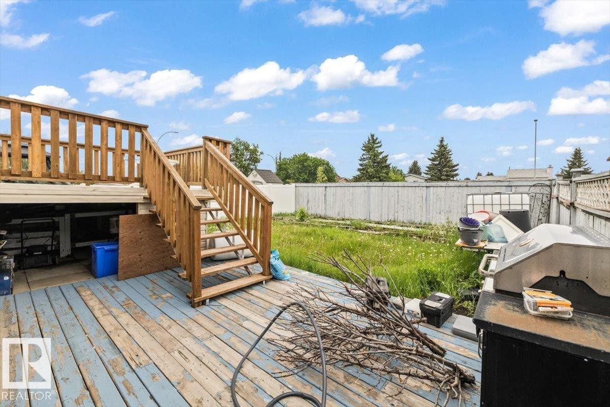 Multi-level wooden deck featuring a staircase and wood railings - 8103 154 Avenue, Edmonton, AB
