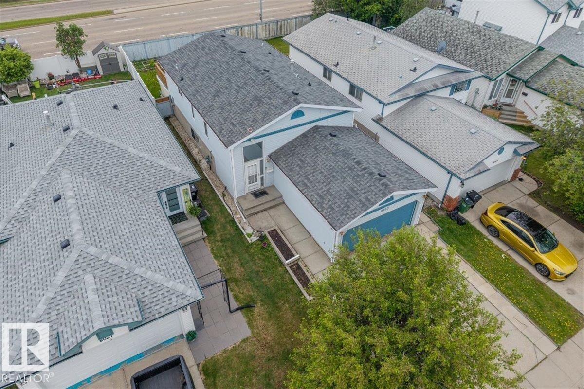 Aerial perspective showcasing a two-story residence with a light-colored exterior and contrasting roofline - 8103 154 Avenue, Edmonton, AB
