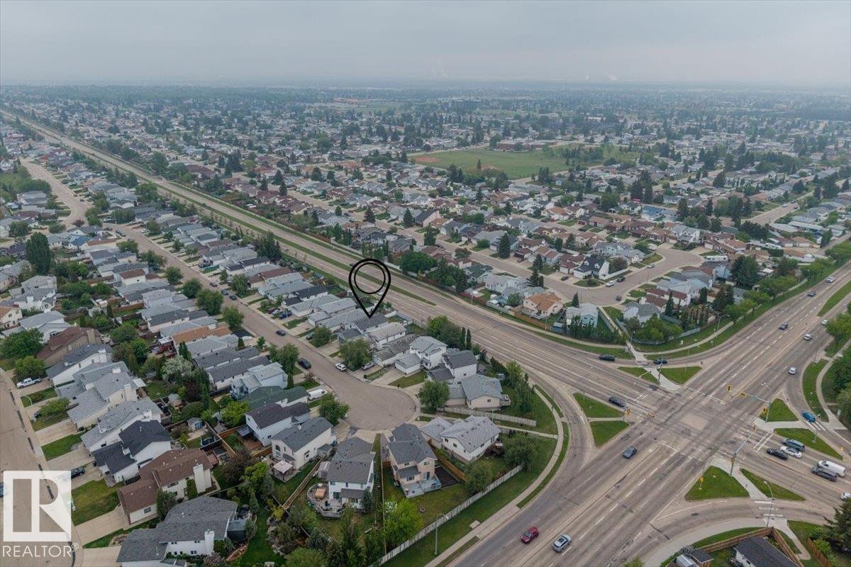 Residential neighborhood featuring a grid-patterned road system, mature tree canopies, and a distinct cul-de-sac - 8103 154 Avenue, Edmonton, AB