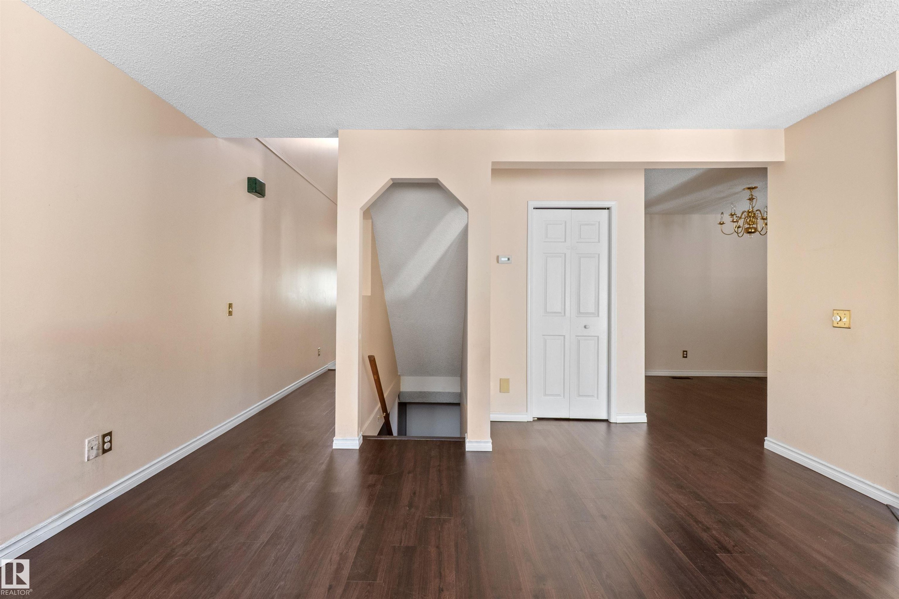 Warm-toned wall paint throughout with dark wood-finish flooring - 5 20 Deerbourne Drive, St. Albert, AB