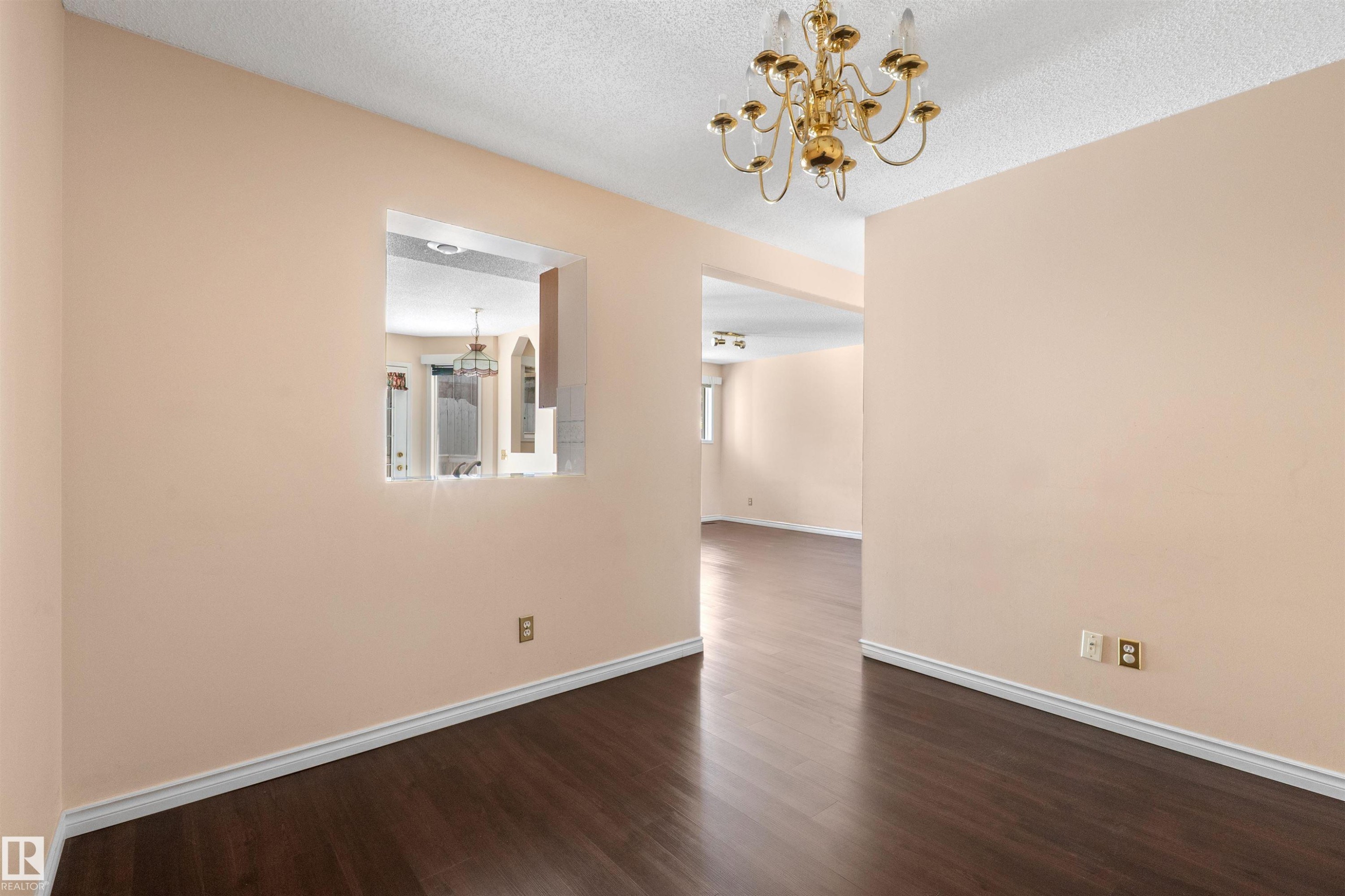 Interior space featuring warm-toned walls and dark wood-finish flooring - 5 20 Deerbourne Drive, St. Albert, AB