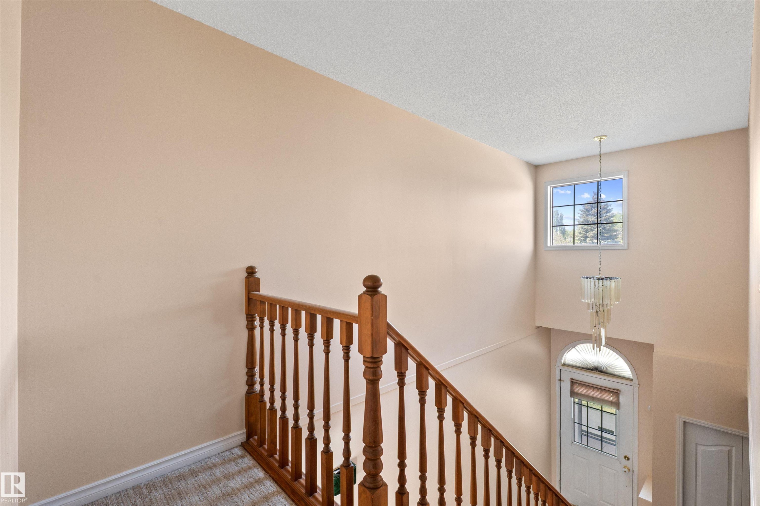 Staircase with wood banister and spindles - 5 20 Deerbourne Drive, St. Albert, AB