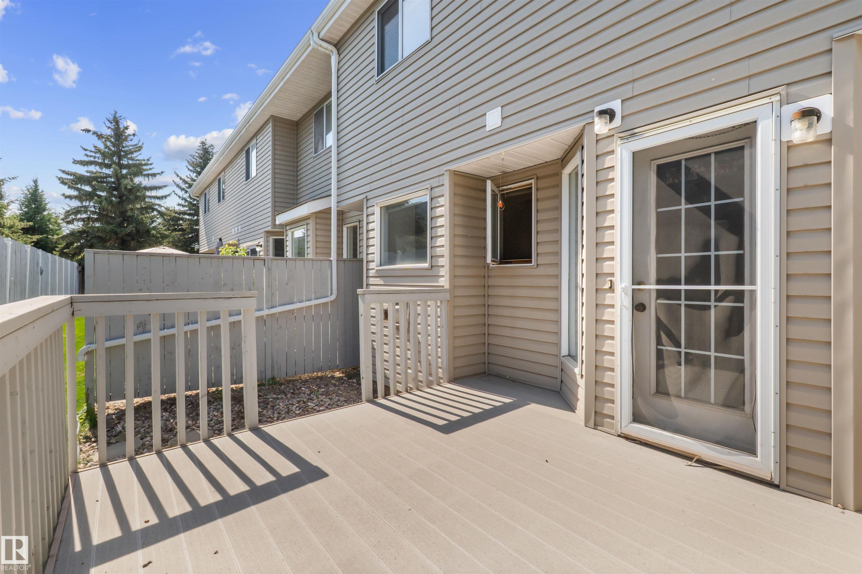 Private exterior deck featuring composite decking and a railing system - 5 20 Deerbourne Drive, St. Albert, AB