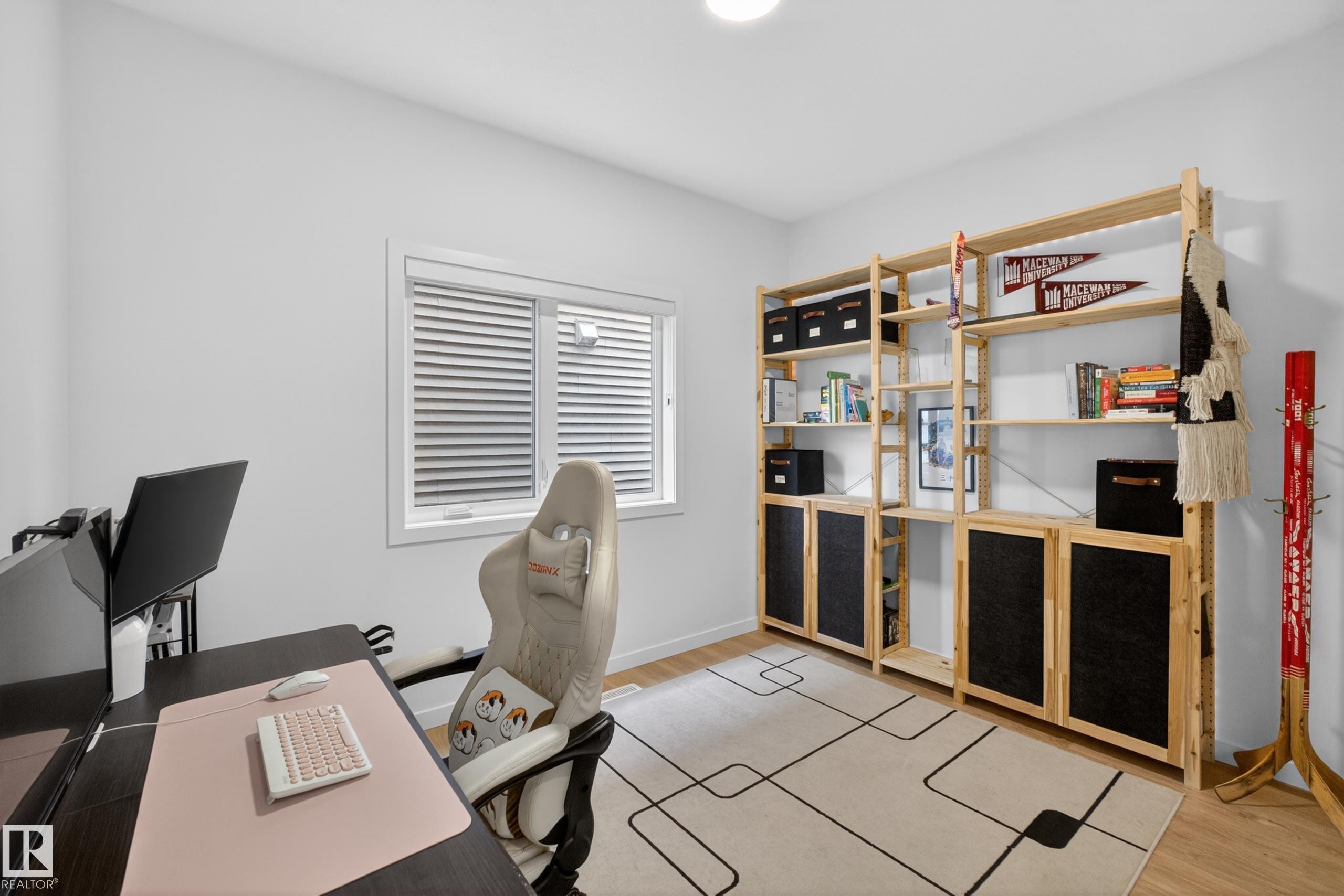 Room featuring light wood-finish flooring, a white ceiling with recessed lighting, and a window with horizontal blinds - 17023 45 Street, Edmonton, AB