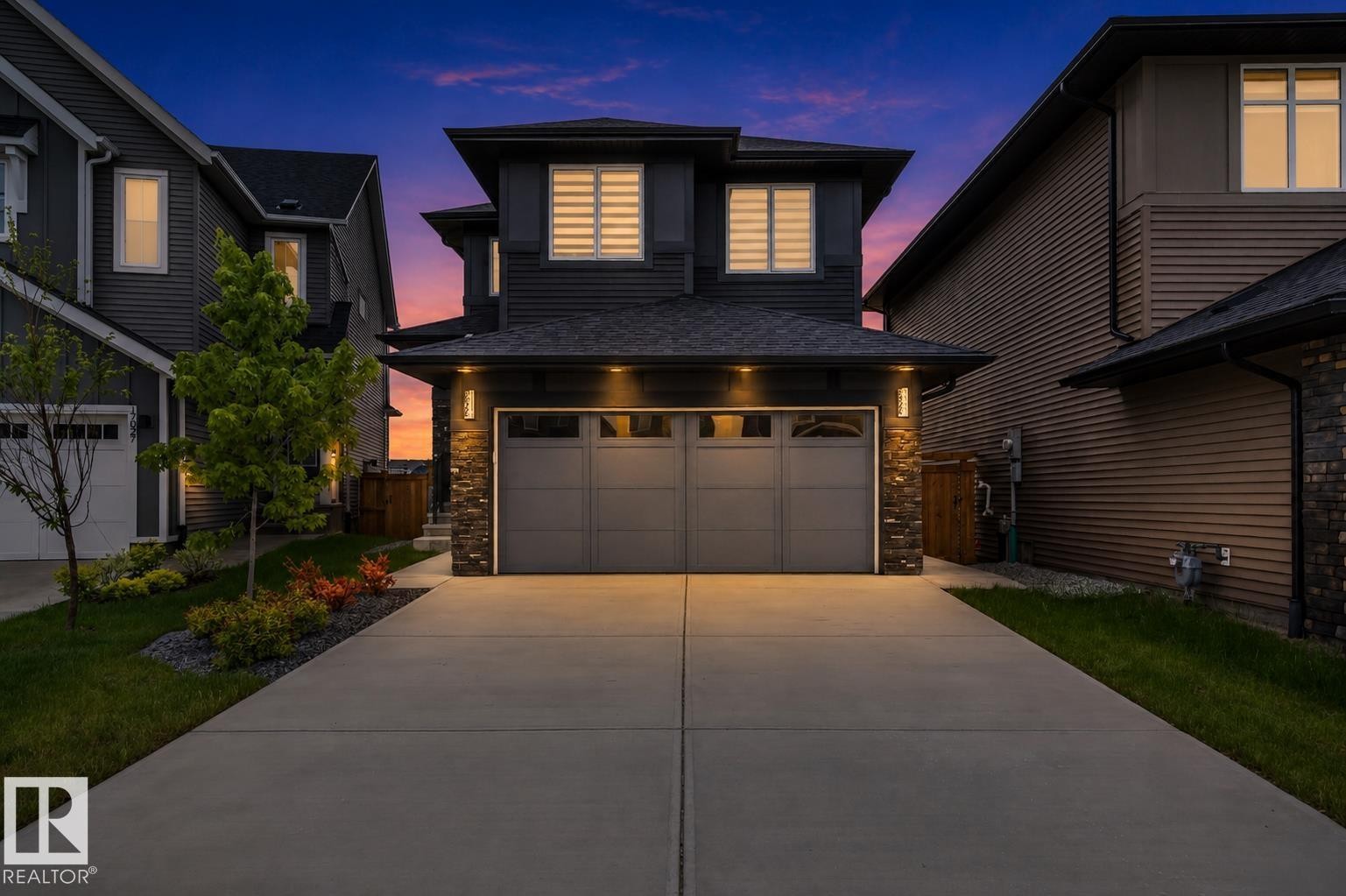 Modern two-story residence featuring a two-car garage with a concrete driveway - 17023 45 Street, Edmonton, AB