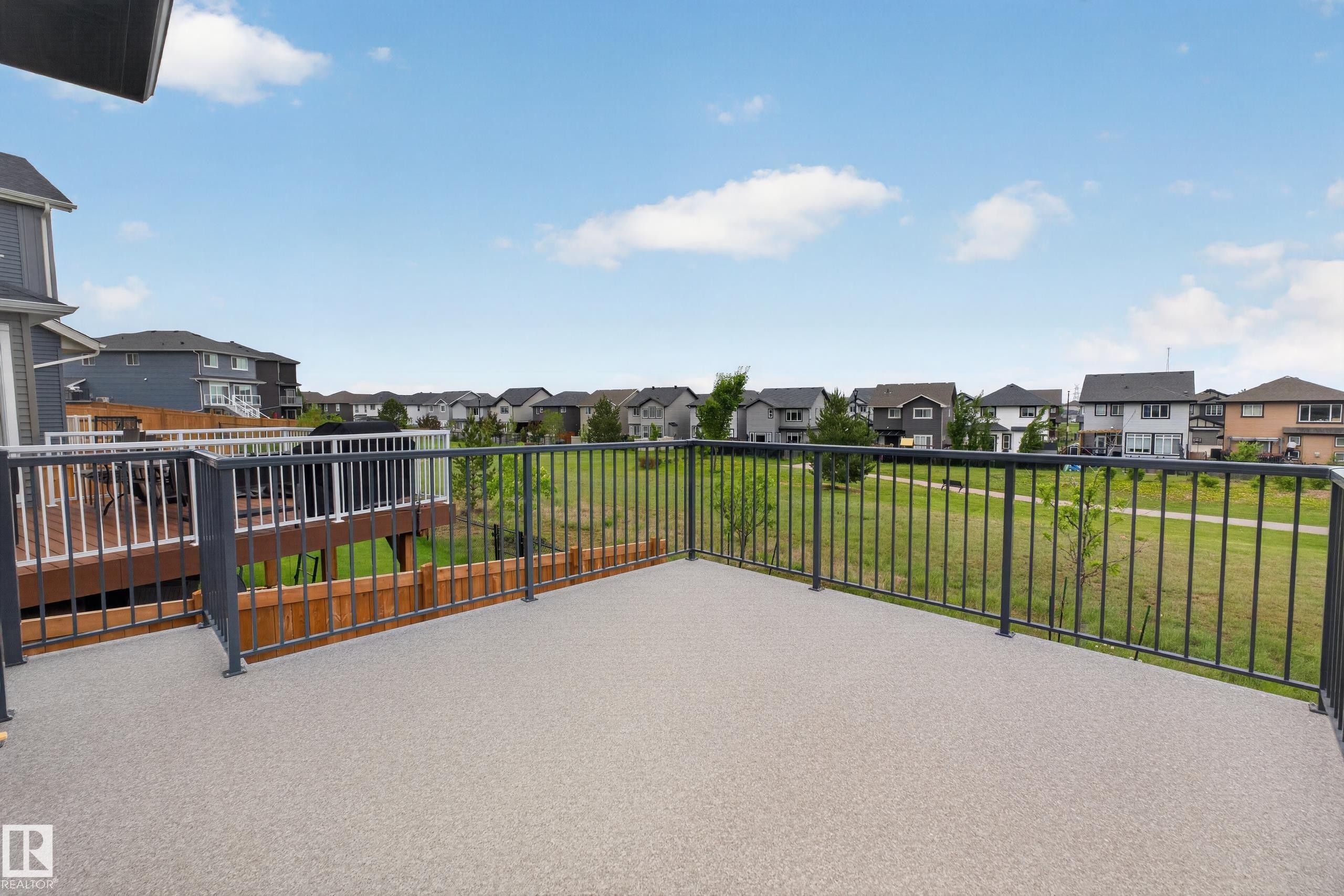 Spacious outdoor deck with textured surfacing and dark metal railings - 17023 45 Street, Edmonton, AB