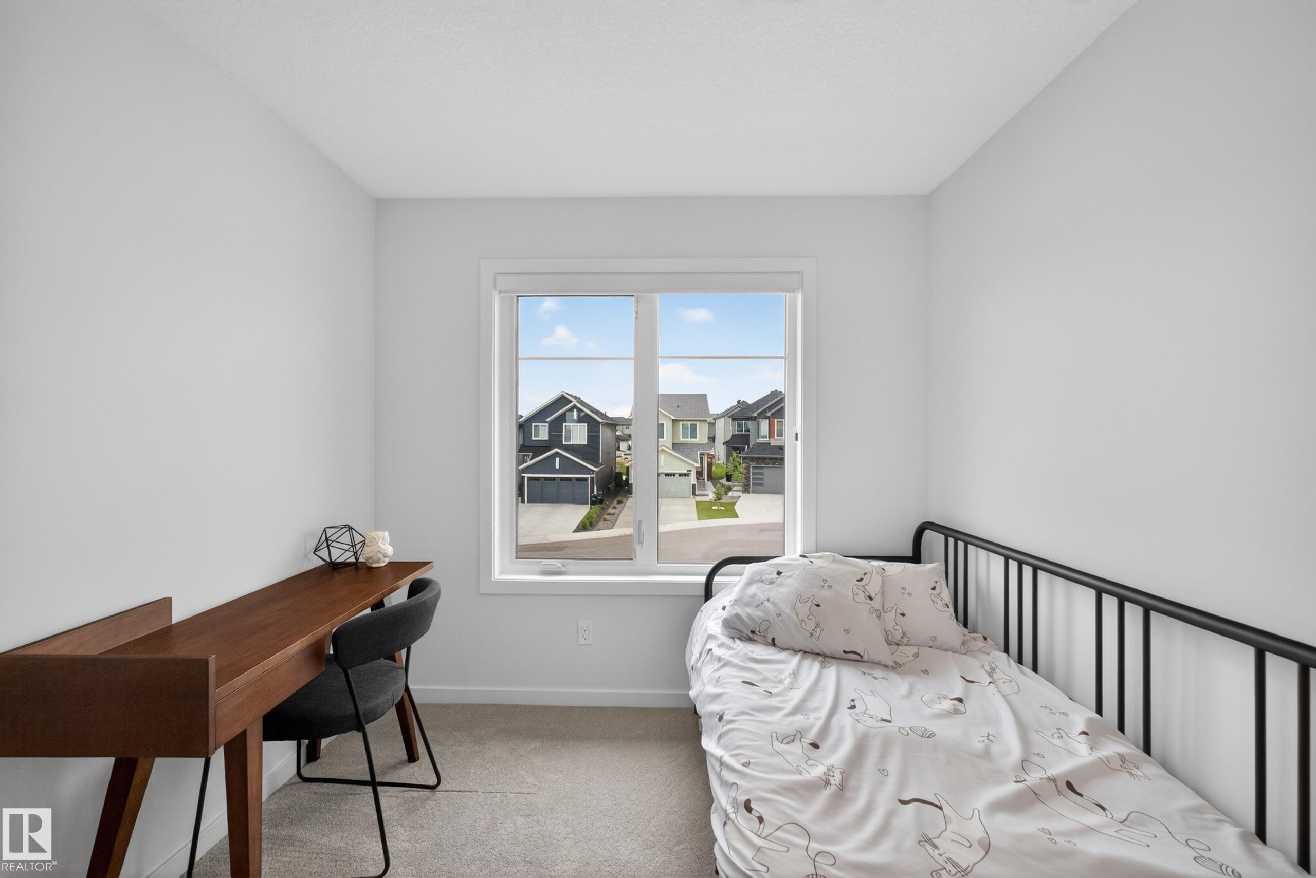 Bright interior room with a large window, light gray carpet, and white painted walls - 17023 45 Street, Edmonton, AB