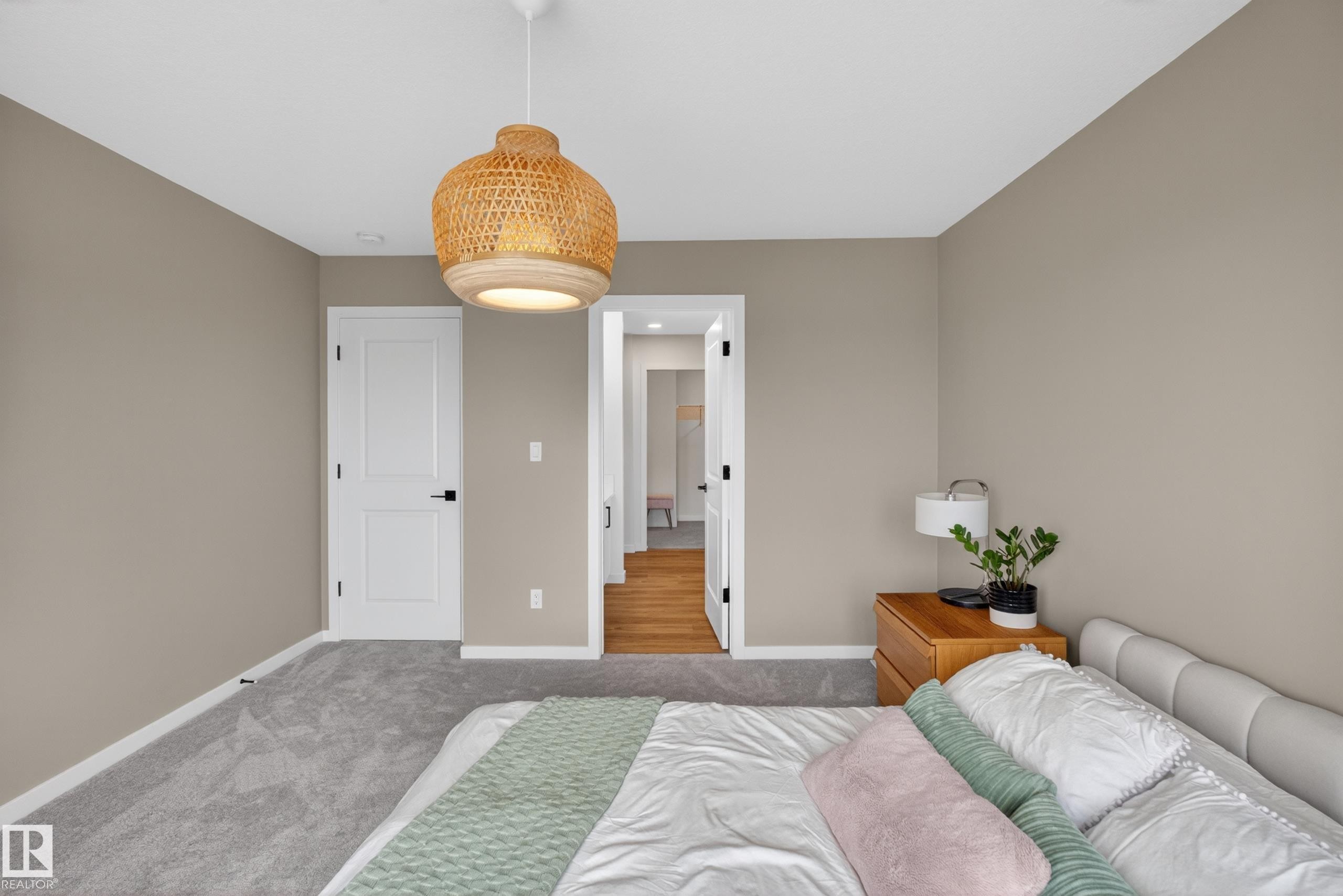 Room featuring a woven pendant light fixture, light gray walls, and gray carpet flooring - 17023 45 Street, Edmonton, AB