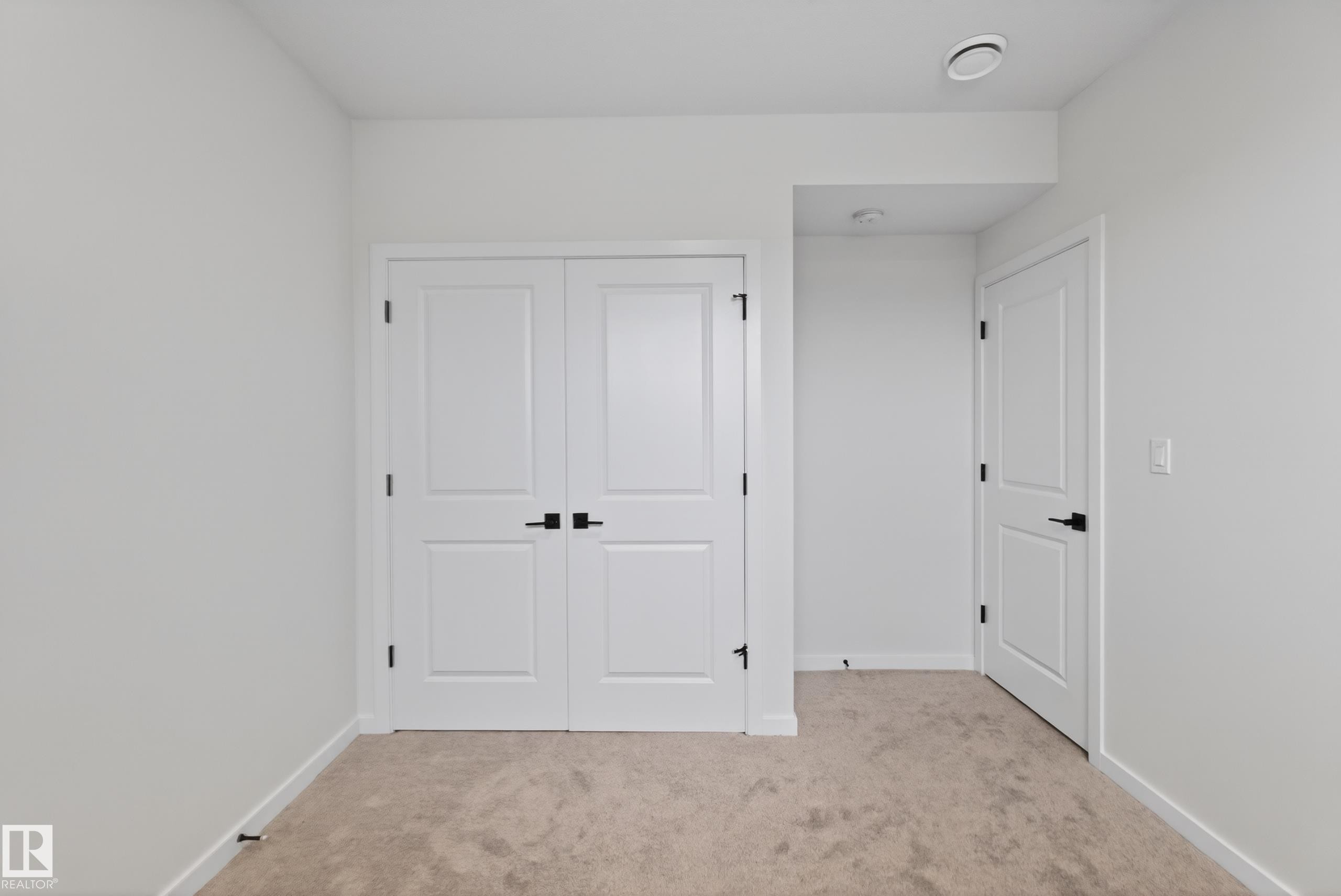 Neutral-toned carpeting and white walls provide a versatile backdrop - 17023 45 Street, Edmonton, AB