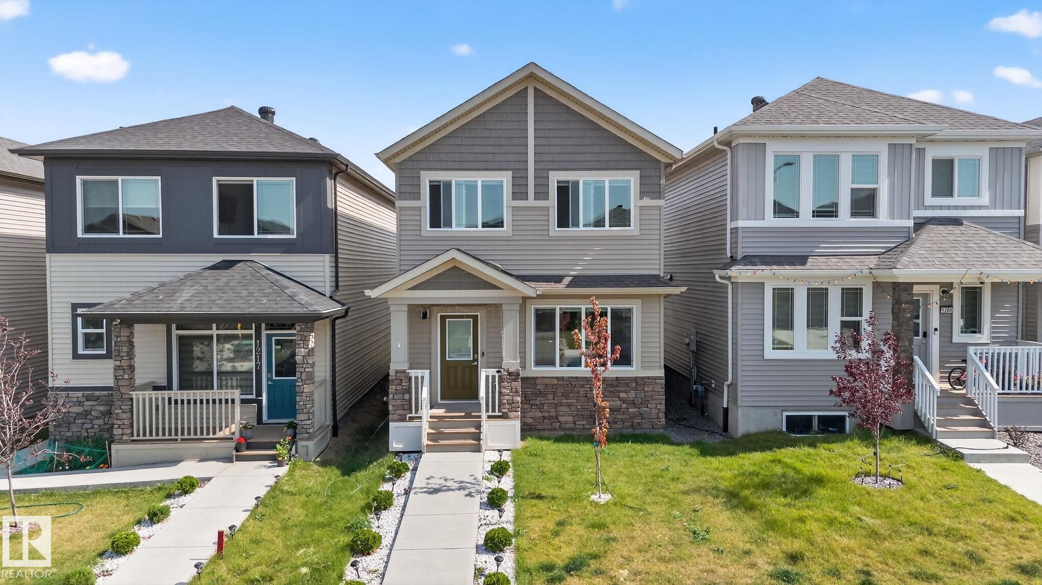 Modern two-story residence with a multi-textured facade featuring horizontal siding and stone accents - 1213 16A Street, Edmonton, AB
