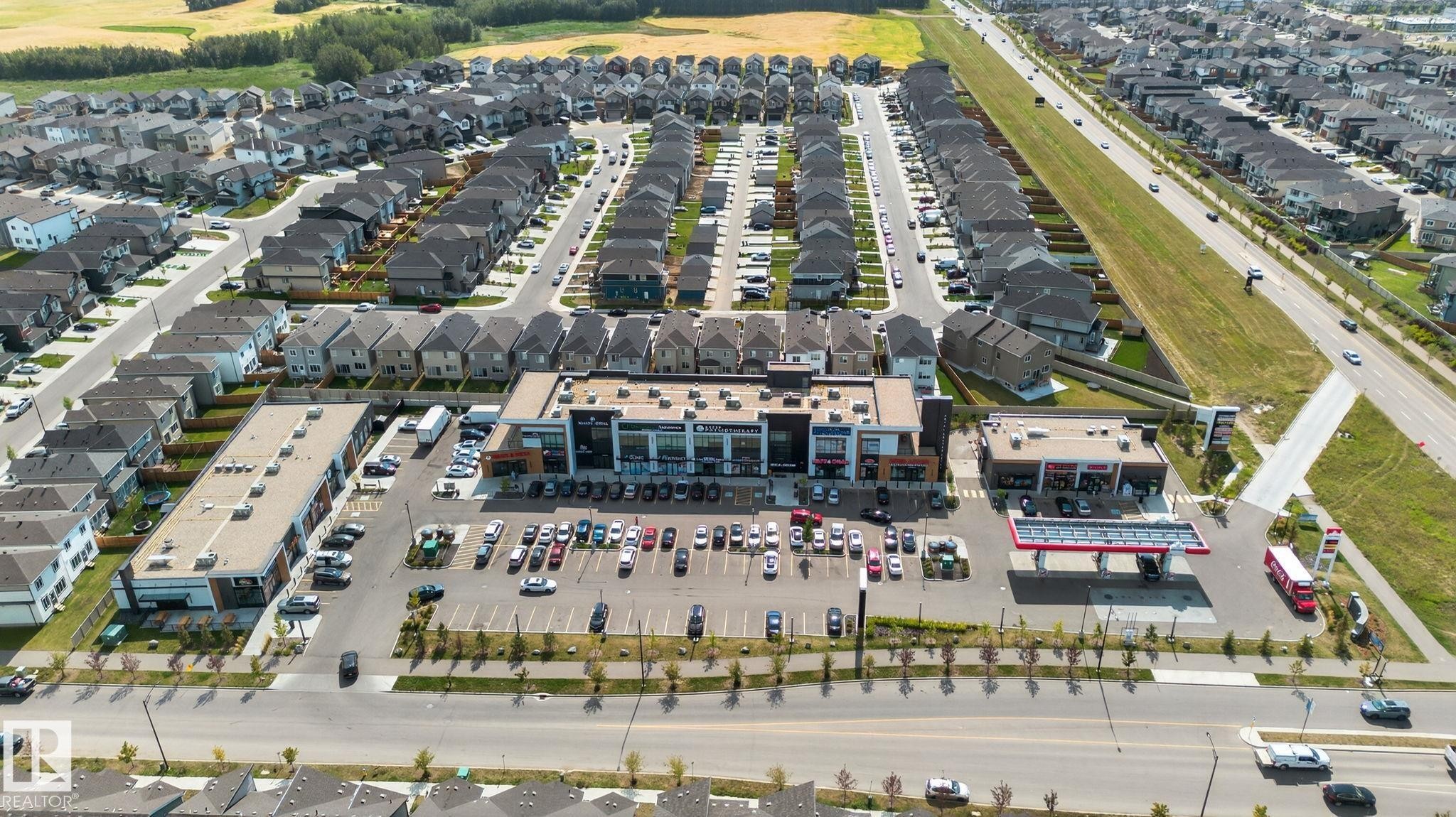 Contemporary commercial building featuring a multi-level design and ample surface parking - 1213 16A Street, Edmonton, AB
