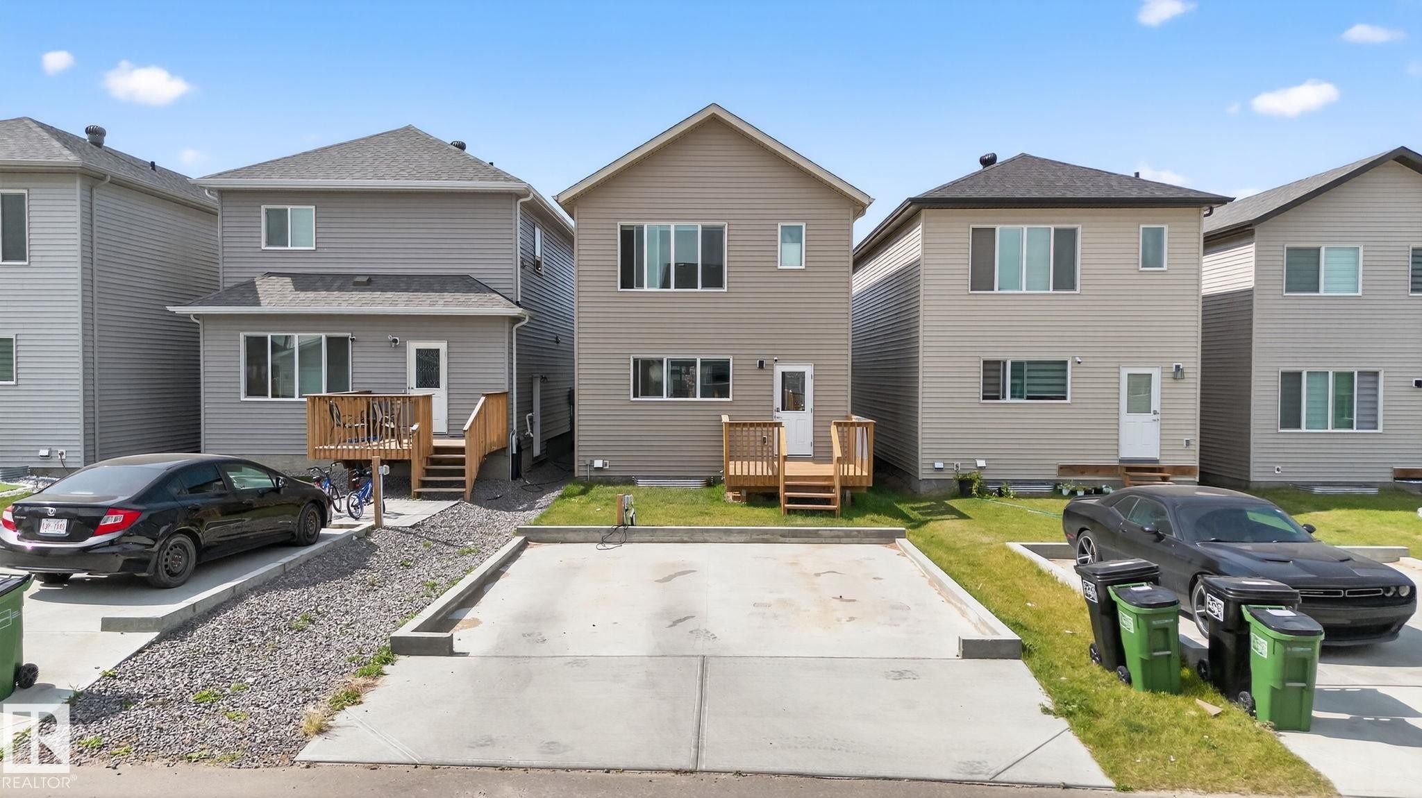 Contemporary two-story residence featuring light beige siding and a dark shingle roof - 1213 16A Street, Edmonton, AB