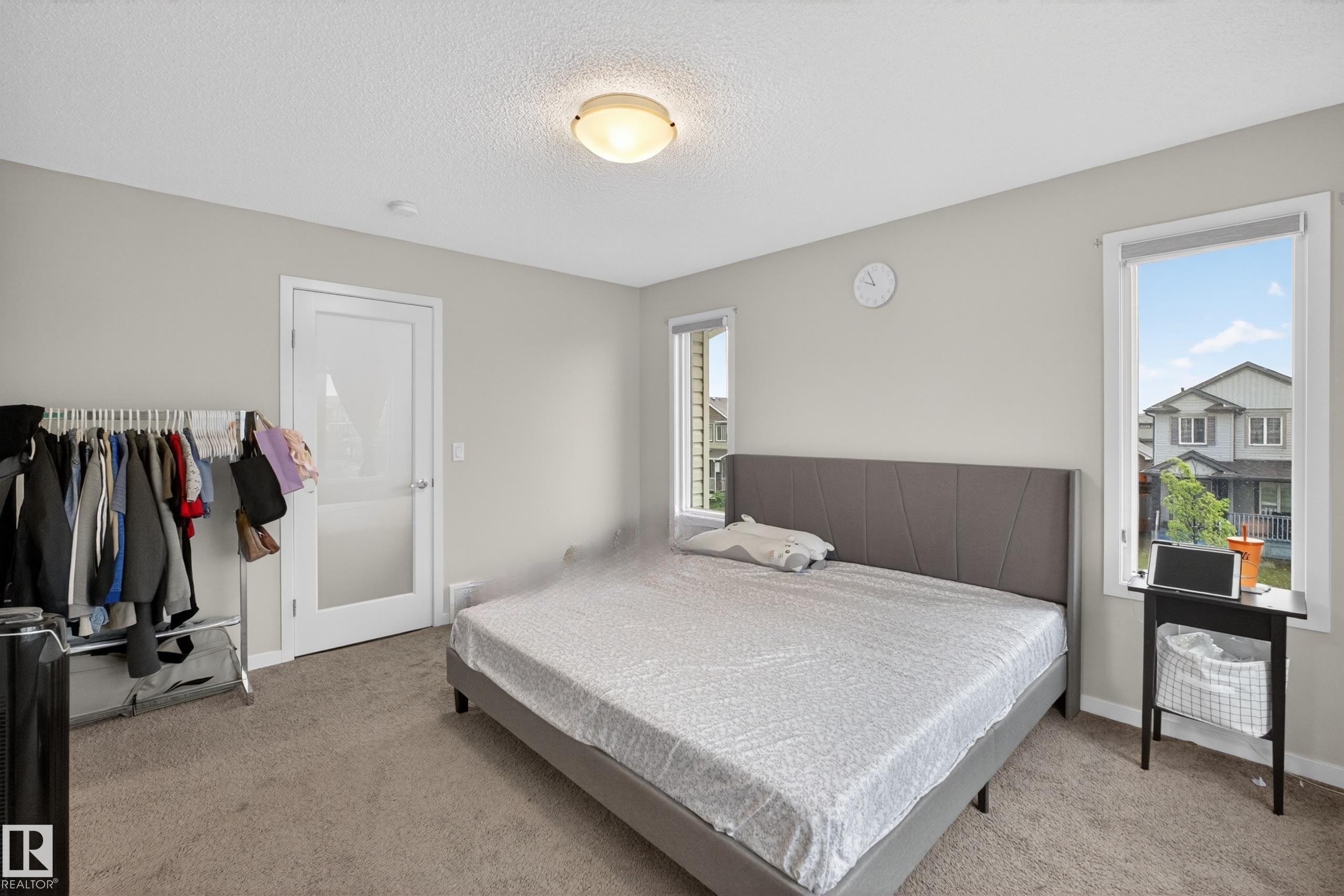 Spacious room with neutral gray walls and carpeting - 1404 25 Avenue, Edmonton, AB