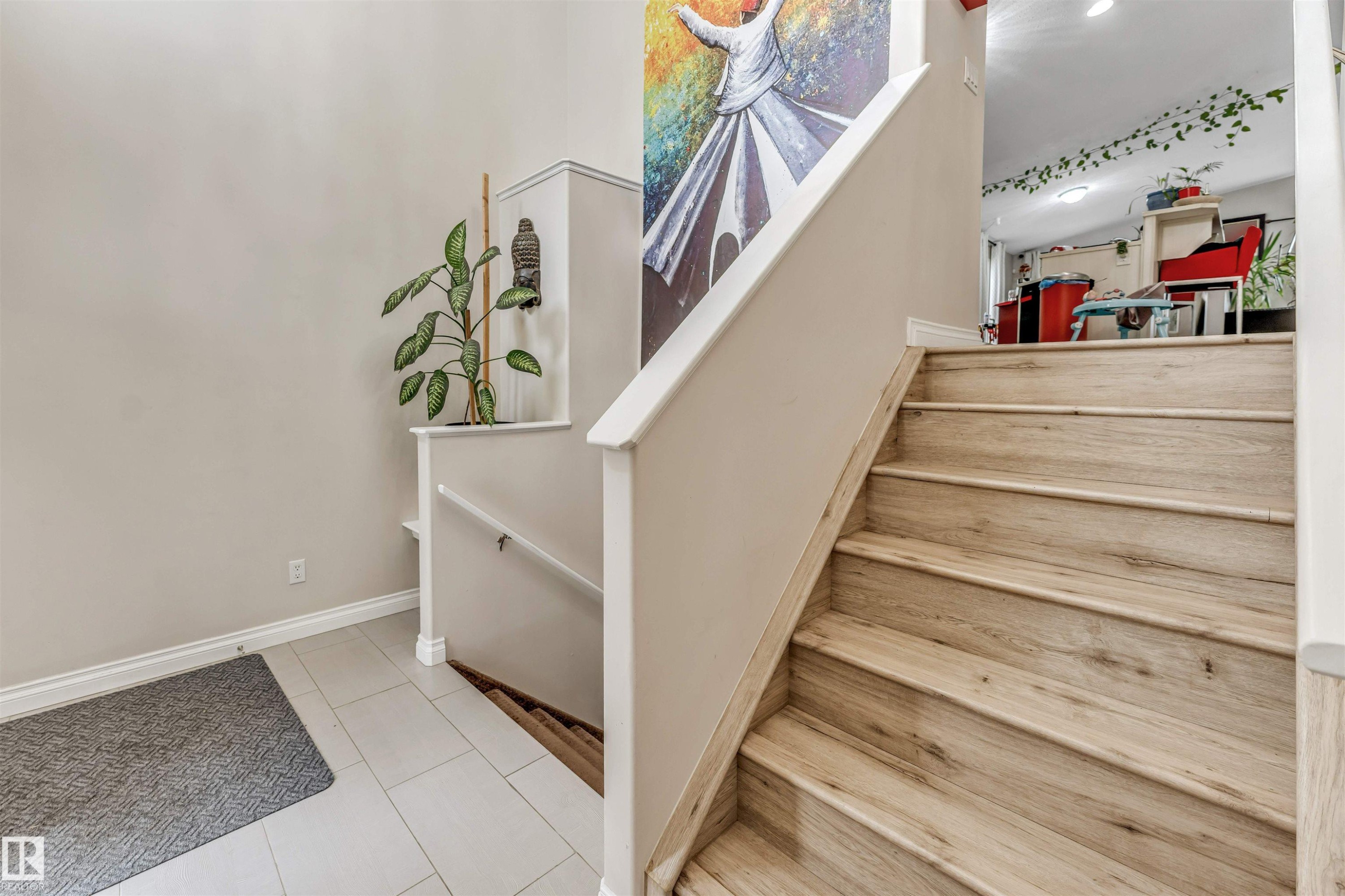 Staircase featuring wood-finish treads and white risers - 3519 22 Street Nw, Edmonton, AB