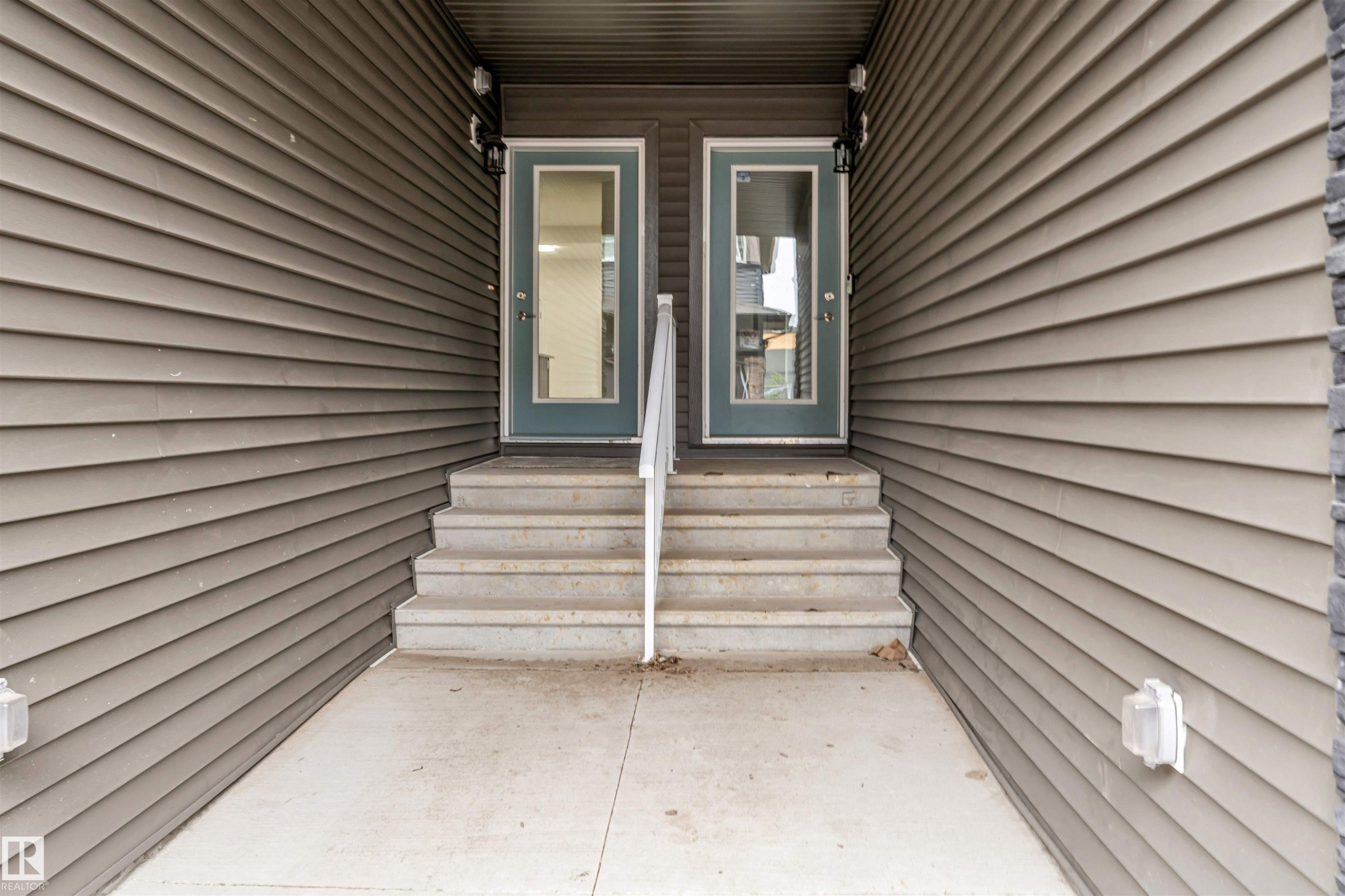 Dual entry doors with full glass panels and a central handrail - 45 2710 66 Street, Edmonton, AB