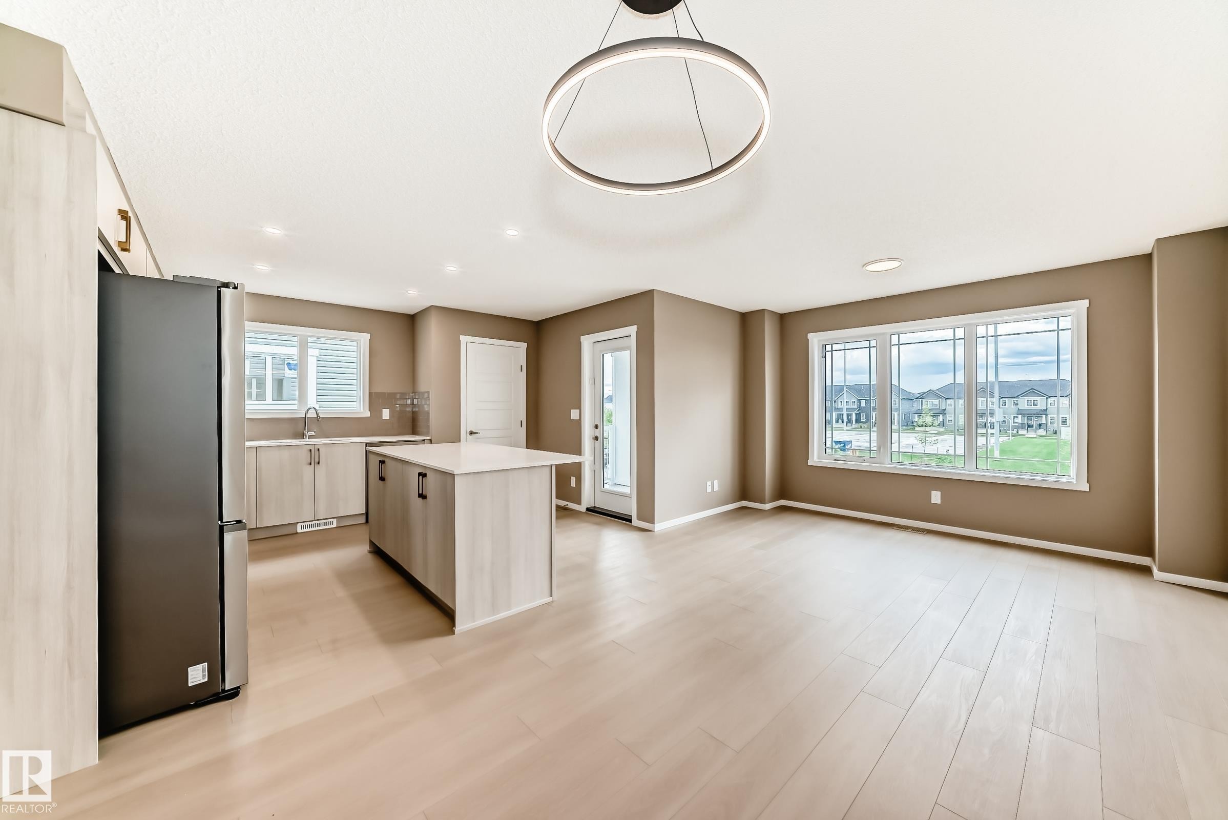 Open-concept living space featuring wood-finish flooring and neutral wall tones - 1210 Stoneside Road, Sherwood Park, AB - Indoor