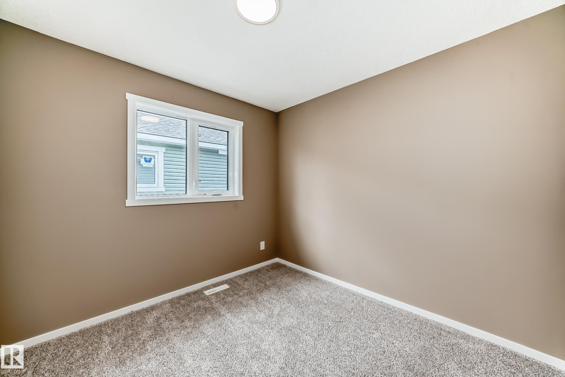 Room featuring neutral-toned walls, white trim, and a window with white casing - 1210 Stoneside Road, Sherwood Park, AB - Indoor Photo Showing Other Room