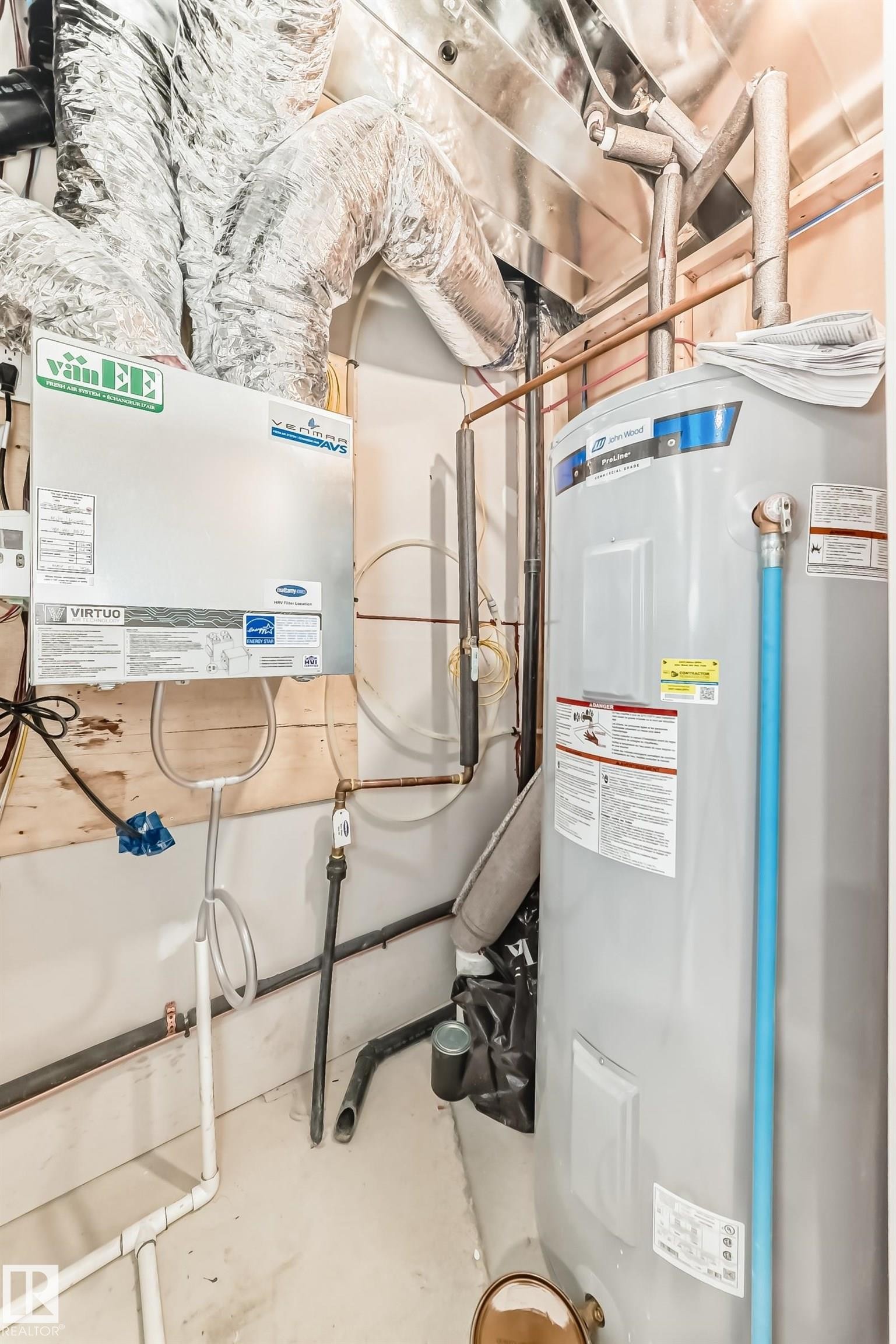 Utility area featuring a water heater, ventilation ducts, and various piping - 1210 Stoneside Road, Sherwood Park, AB - Indoor Photo Showing Basement