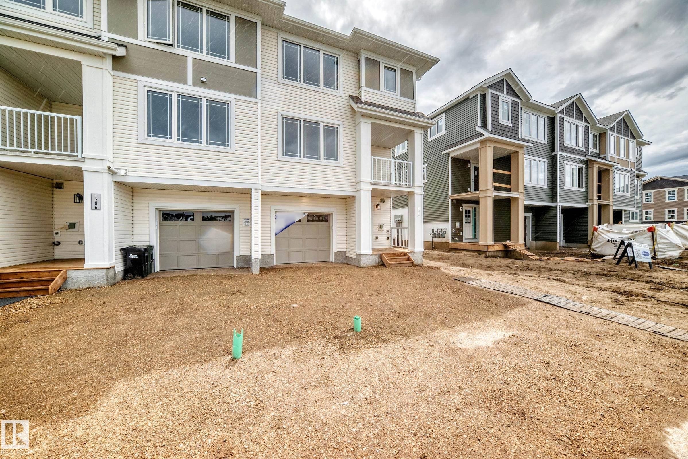 Multi-story residential facade featuring horizontal siding and contrasting accent panels - 1210 Stoneside Road, Sherwood Park, AB - Outdoor With Balcony With Facade