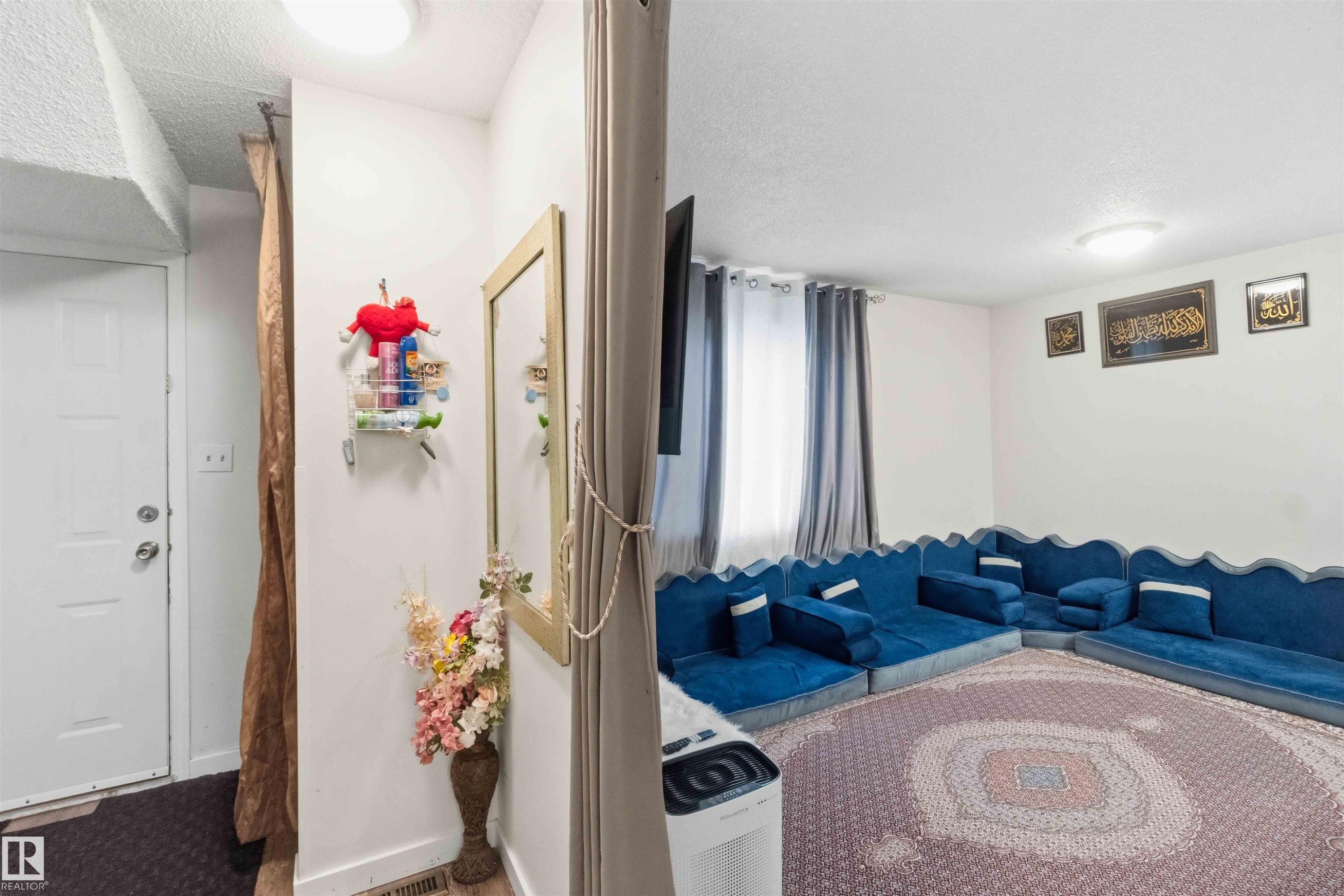 Entryway featuring a white paneled door and overhead lighting - 203 11421 34 Street Nw, Edmonton, AB