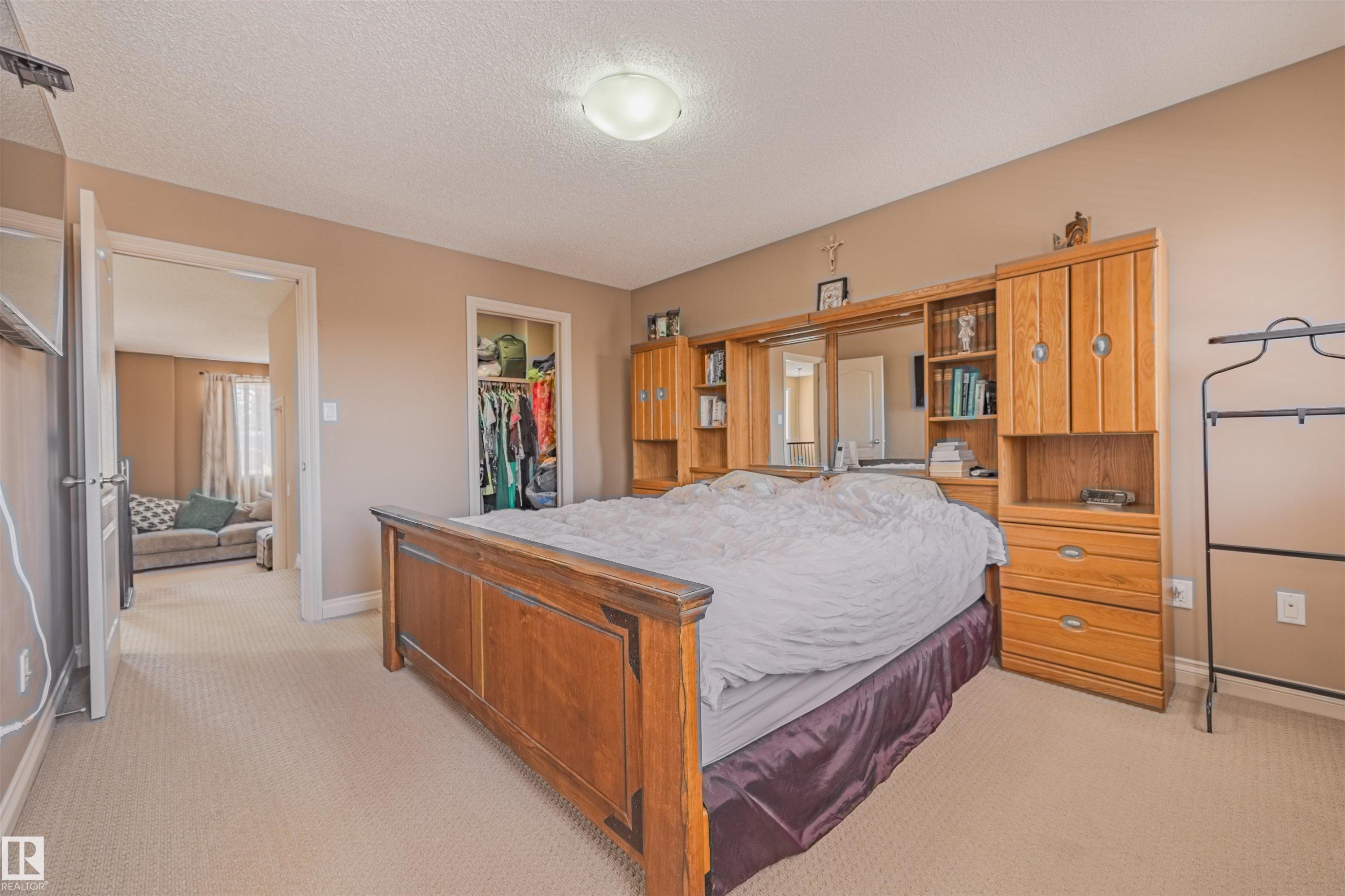 Primary bedroom with view of walk-in closet. - 57 Homestead Crescent Nw, Edmonton, AB - Indoor Photo Showing Bedroom