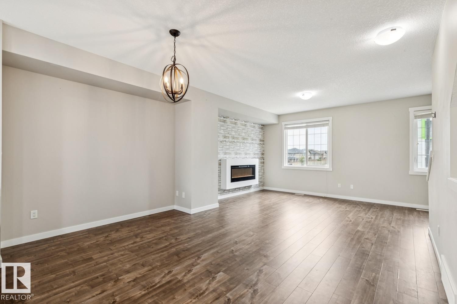 739 Allard Boulevard Sw, Edmonton, AB - Indoor Photo Showing Living Room With Fireplace