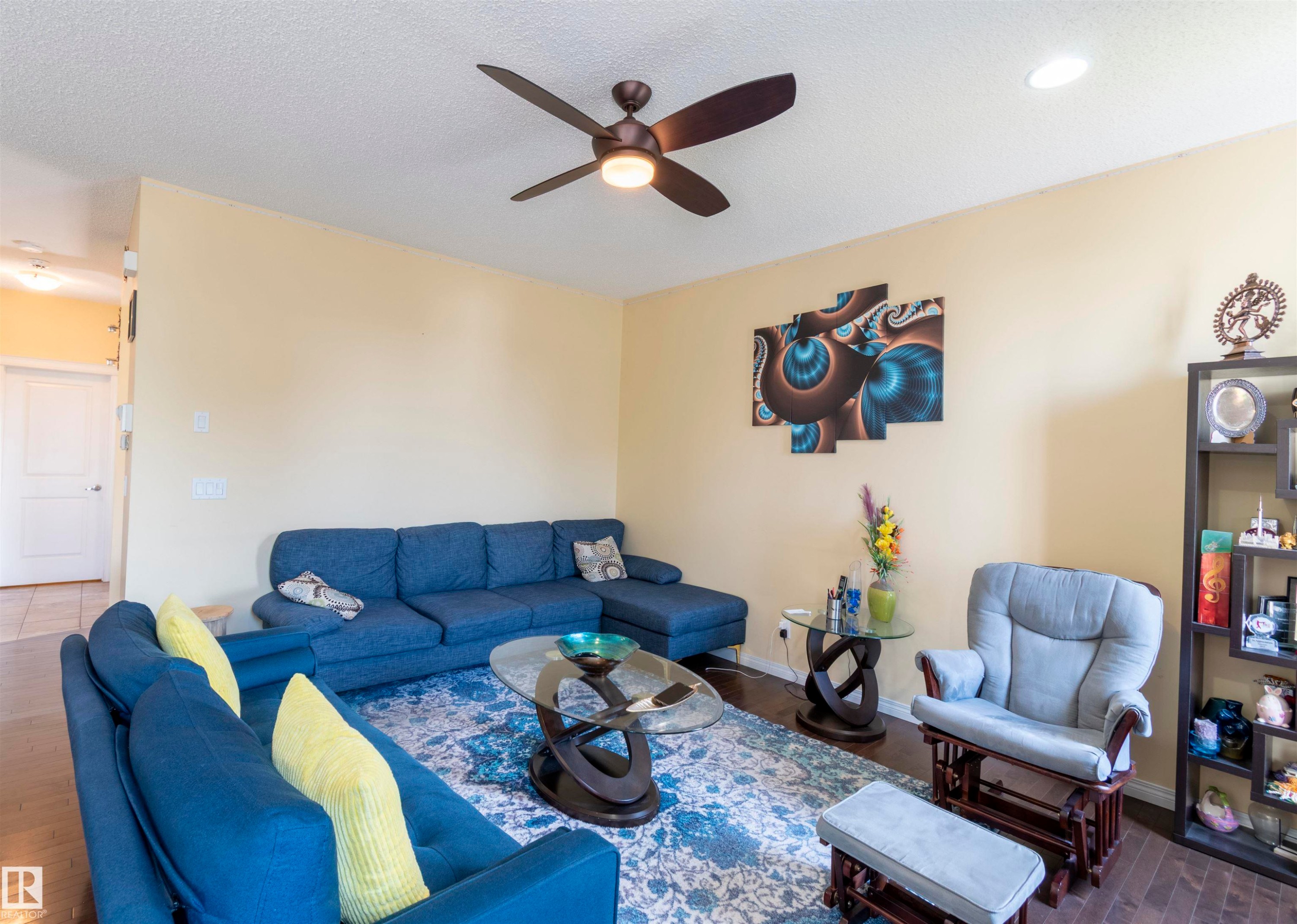Living area featuring wood-finish flooring, recessed lighting, and a ceiling fan - 1840 56 Street, Edmonton, AB