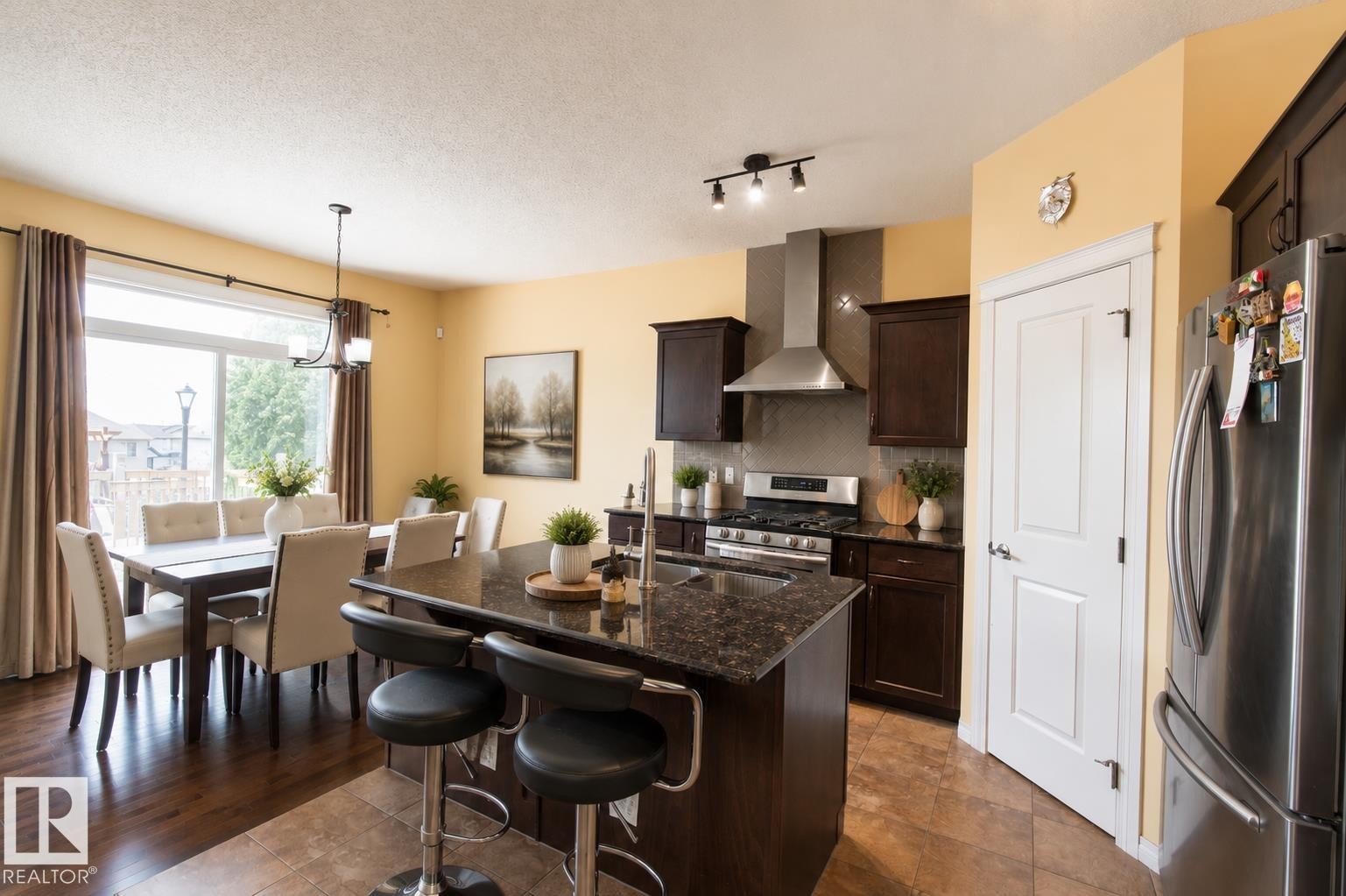 Kitchen island with a dark countertop and integrated sink - 1840 56 Street, Edmonton, AB
